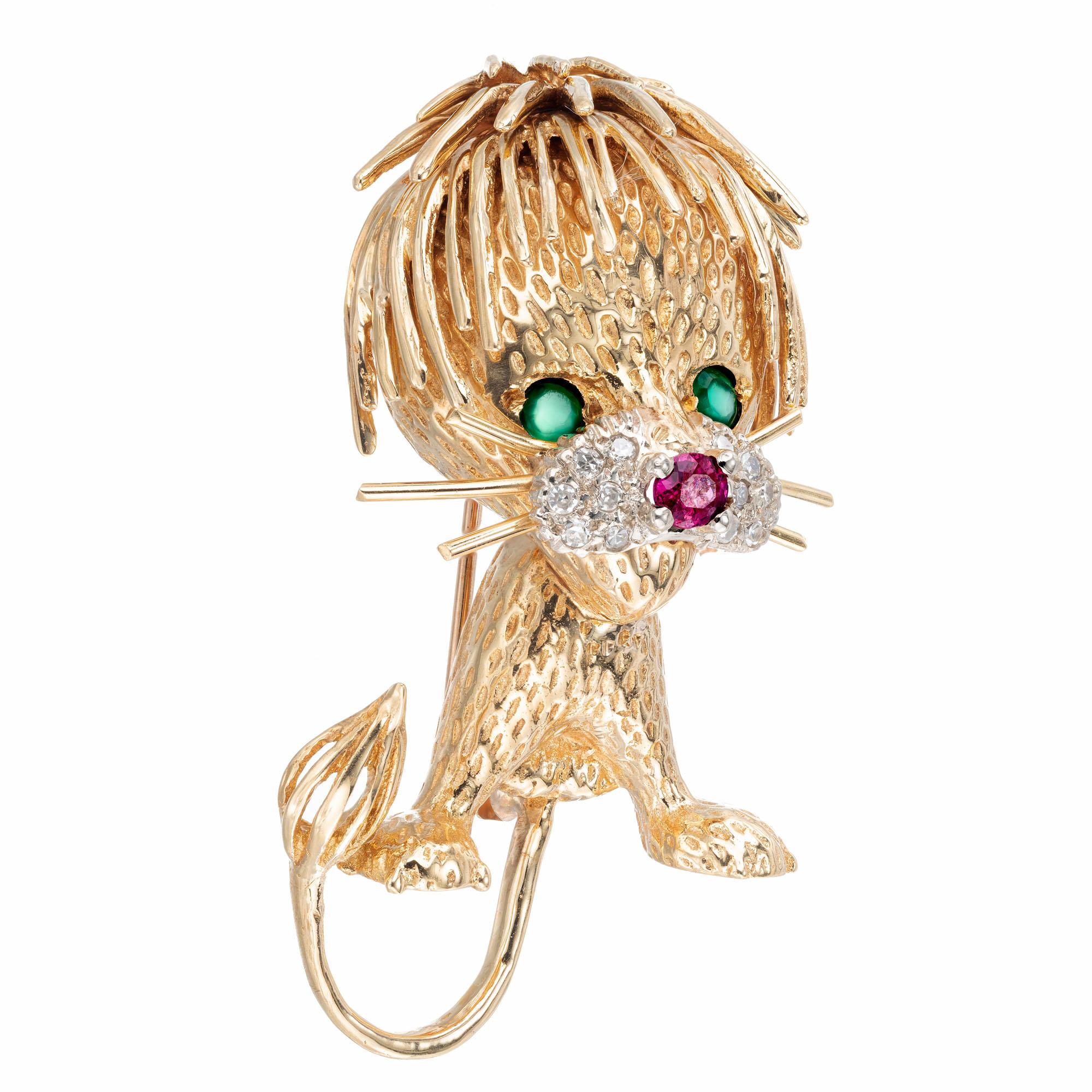Lion cub 18k yellow gold brooch with ruby, emerald and white diamonds. Signed CF. Hand textured. 

12 single cut diamonds approx. total weight .15cts, H, VS - SI 
Two 2.5mm genuine Emeralds approx. total weight .20cts 
One 3mm blood red genuine Ruby