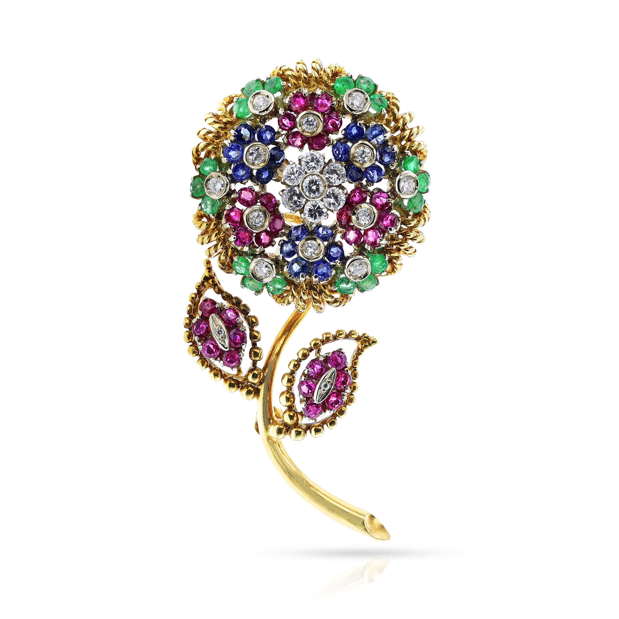 A Ruby, Emerald, Sapphire and Diamond Floral Brooch made in 18k Gold. The stones weigh approximately: 1.10 ct. Diamond, 1.60 ct. Sapphire, 1.44 ct. Emerald, Ruby: 2.7 cts. The brooch dimensions are 2.25