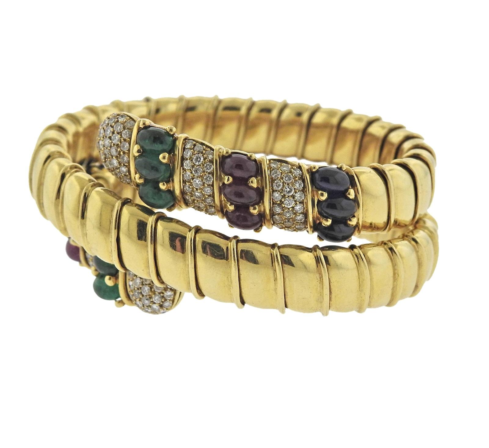 Beautiful 18k gold Italian crafted wrap bracelet, featuring sapphire, emerald and ruby cabochons, surrounded with approximately 2.40ctw in VS/GH diamonds. Bracelet will fit approx. 7