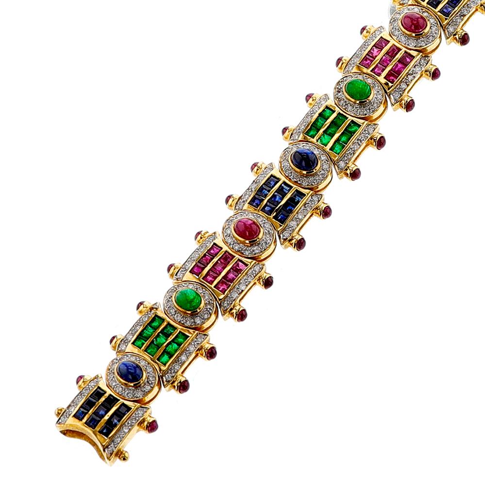 This exquisite bracelet is crafted in 18k yellow gold and features a mixture of five stones: ruby, emerald, sapphire, diamond, and cabochon. The length of the piece is 7 inches, with a total weight of 44.20 grams. A timeless piece that will add a