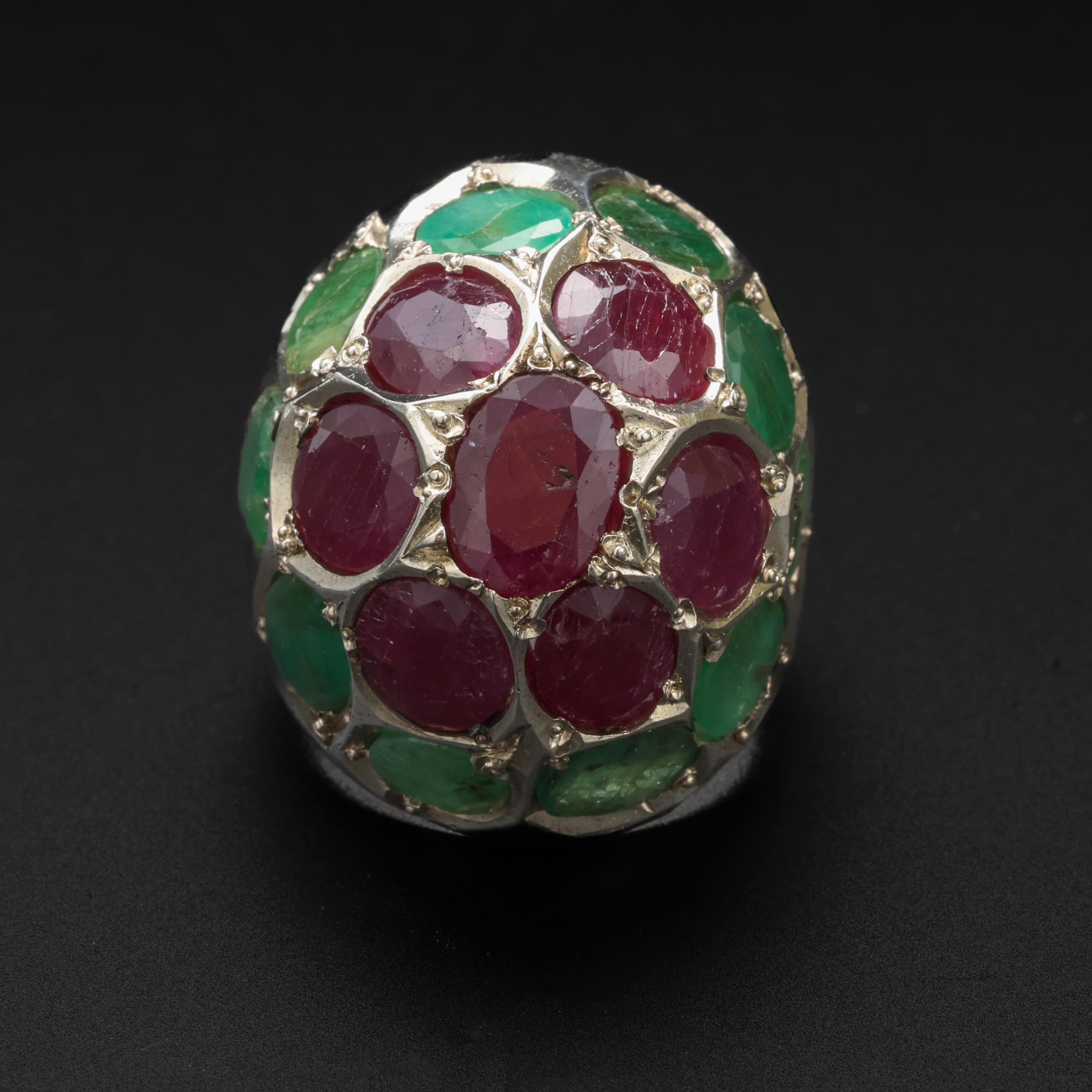 A joy of a ring. Hand-crafted (most likely) in India from 10 natural oval emeralds weighing approximately 12 carats and 7 natural rubies weighing approximately 10.5 carats for a total carat weight of approximately 22.5 carats of earth-mine gems!