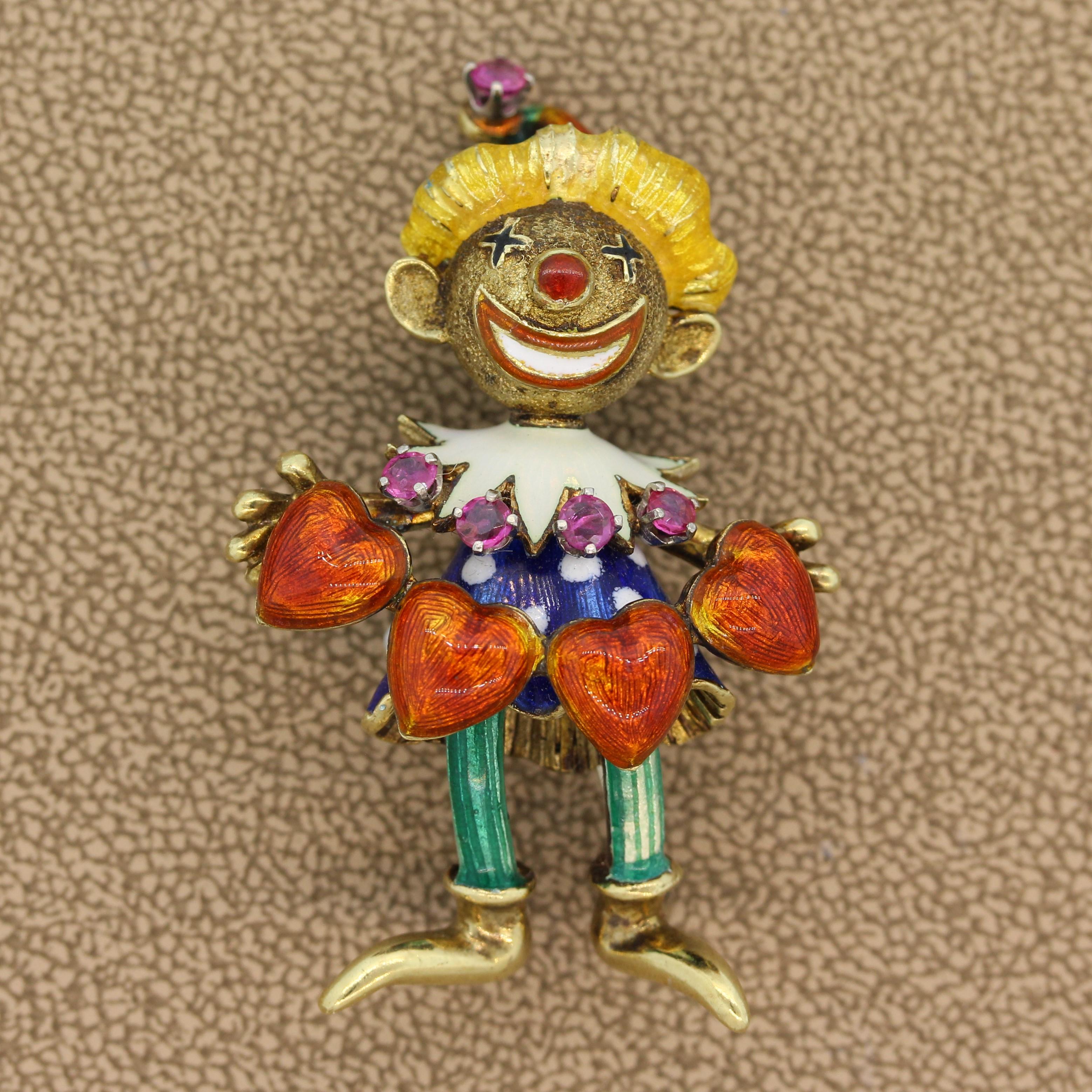 This adorable castle jester with a moving head has been hand painted with enamel. It features 0.55 carats of round cut rubies which decorate its gown. The brooch is comprised of 14K yellow gold. A whimsical piece of jewelry ready to bring life to