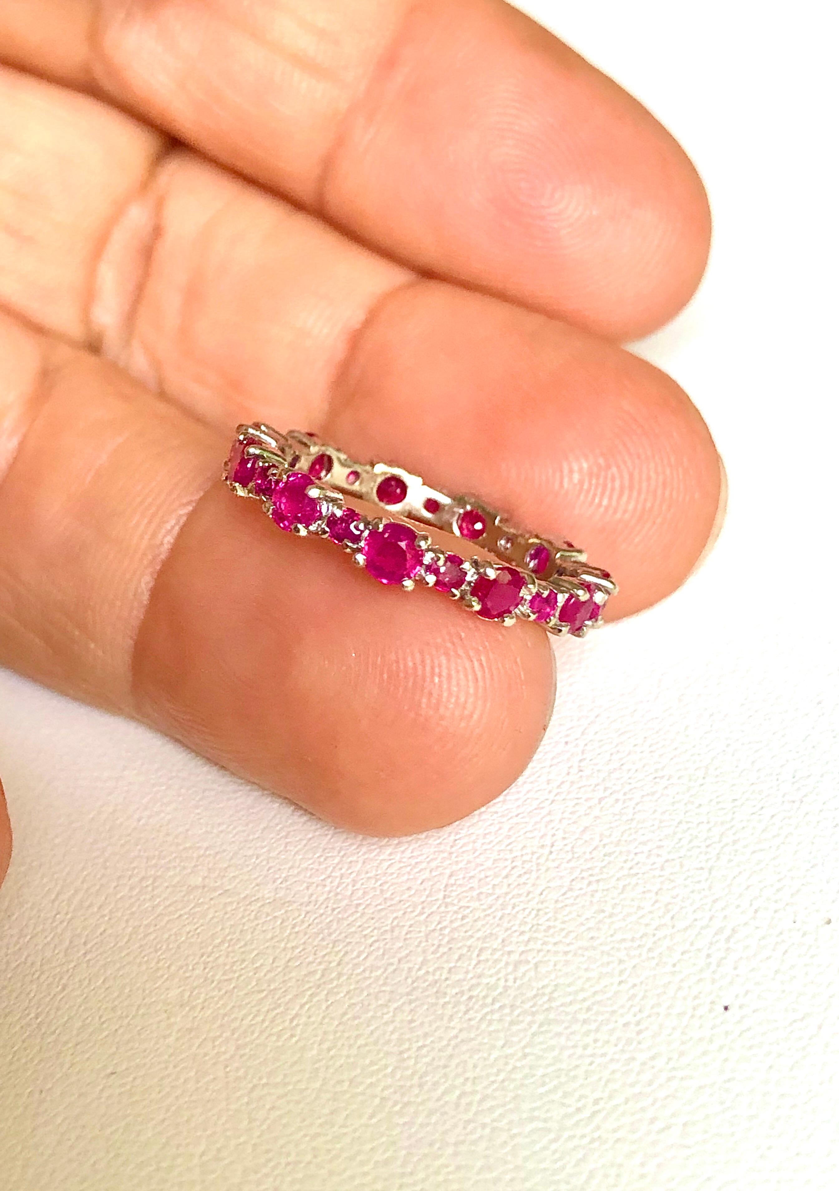 Engagement Eternity Ruby Gold Band Ring Beautifully made ruby eternity band. 26 round cut Ruby weigh a total of 2.0 carat. The band is 3.4mm wide. The band is made of 14k white gold. US size 7.25

The Emeralds Maravellous Jewelry design team can
