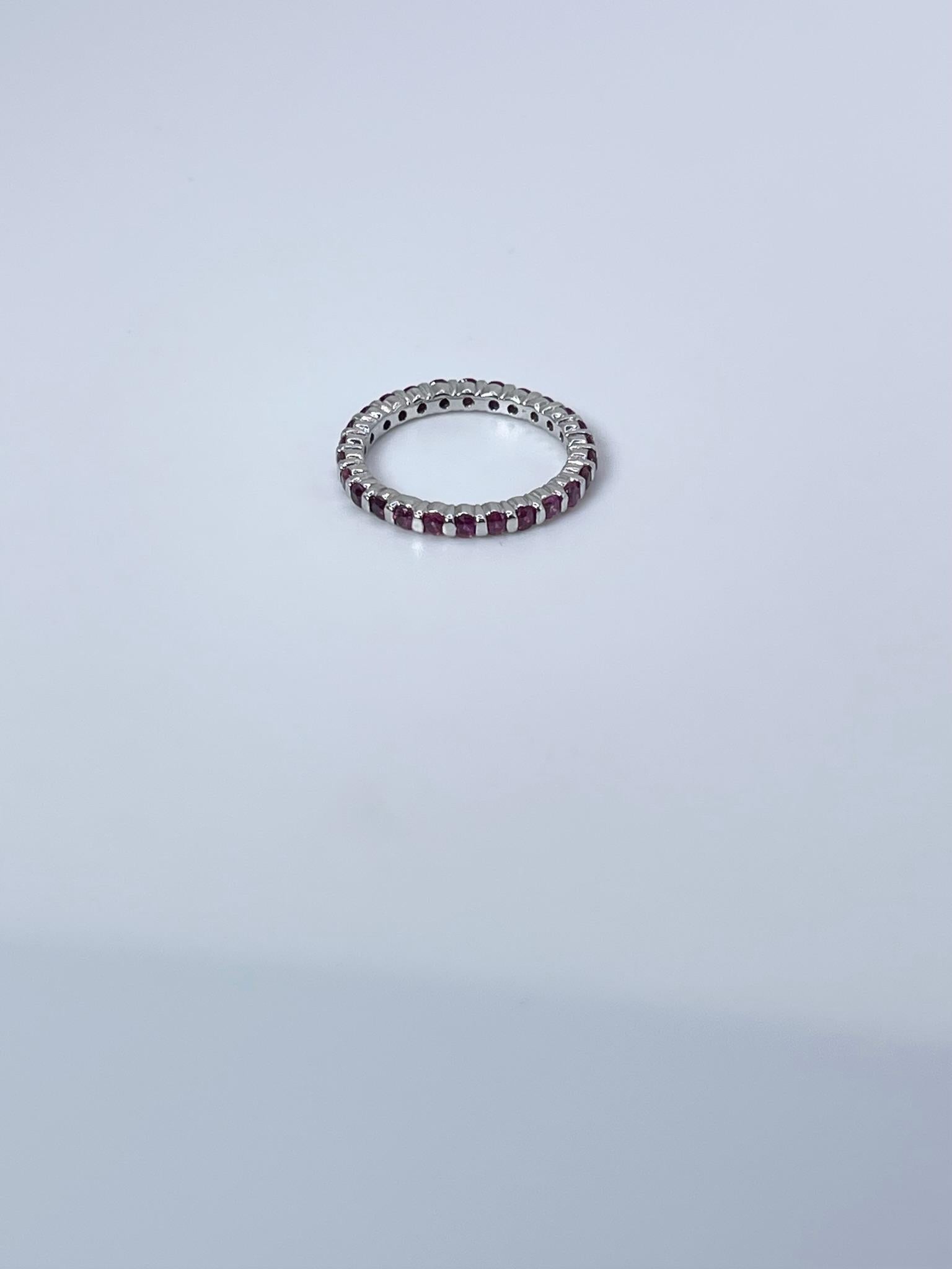 Stunning round eternity ring made with 14KT white gold and natural red rubies, untrated.
ITEM#: MFK 200-00044
GRAM WEIGHT: 2.36gr
METAL: 14KT

NATURAL DIAMOND(S)
Cut: Round 
Color: Pinkish Red
Clarity: Slightly Included
Carat: 1.14ct
Size: 6.5 (