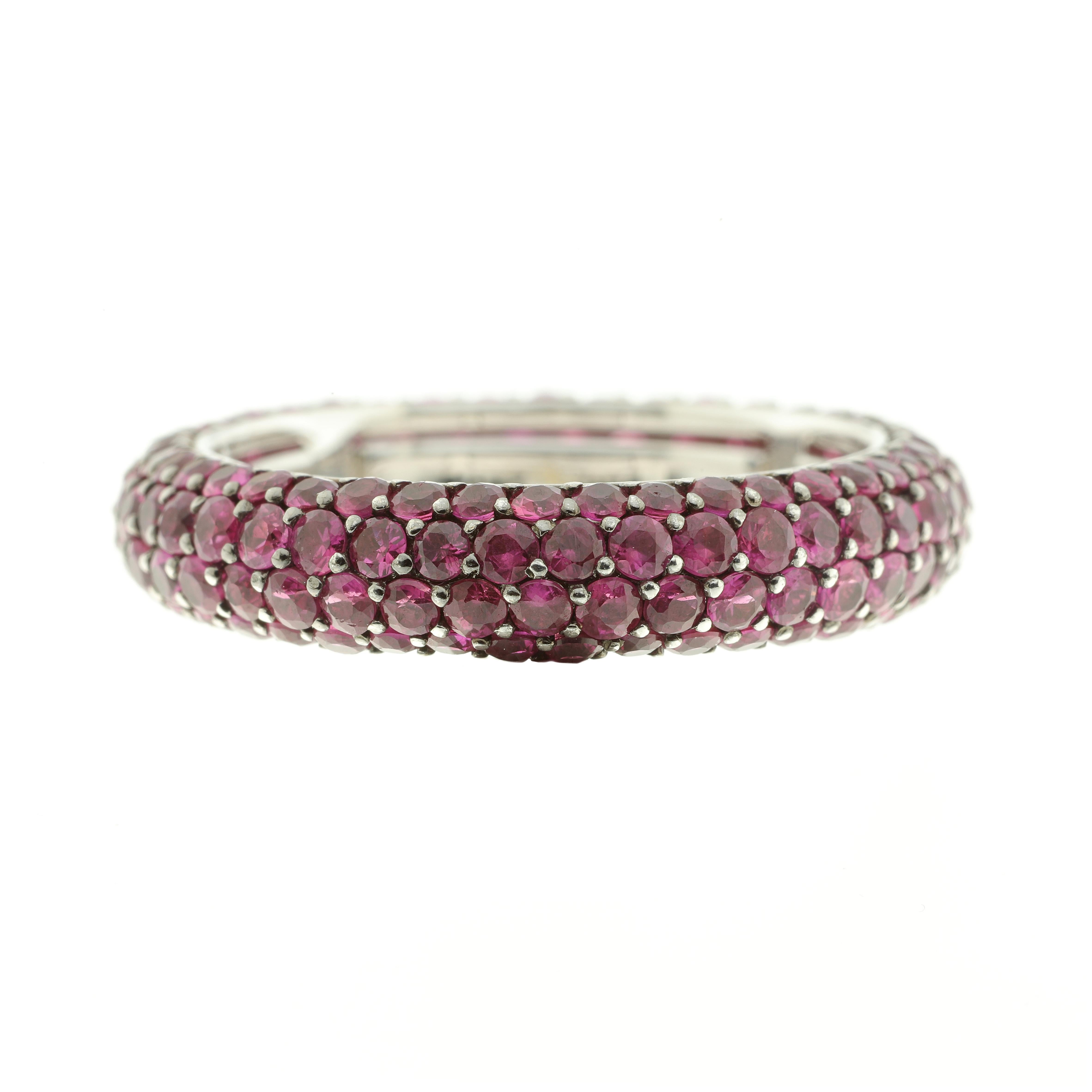 This 18-karat white gold and 3.59-carat ruby eternity band is luxuriously sleek and modern. 
The ring is fabulous to wear. Inside the band are a series of sprung sizers that comfortably fit the band to your finger between US sizes 6 and 7.25.

The