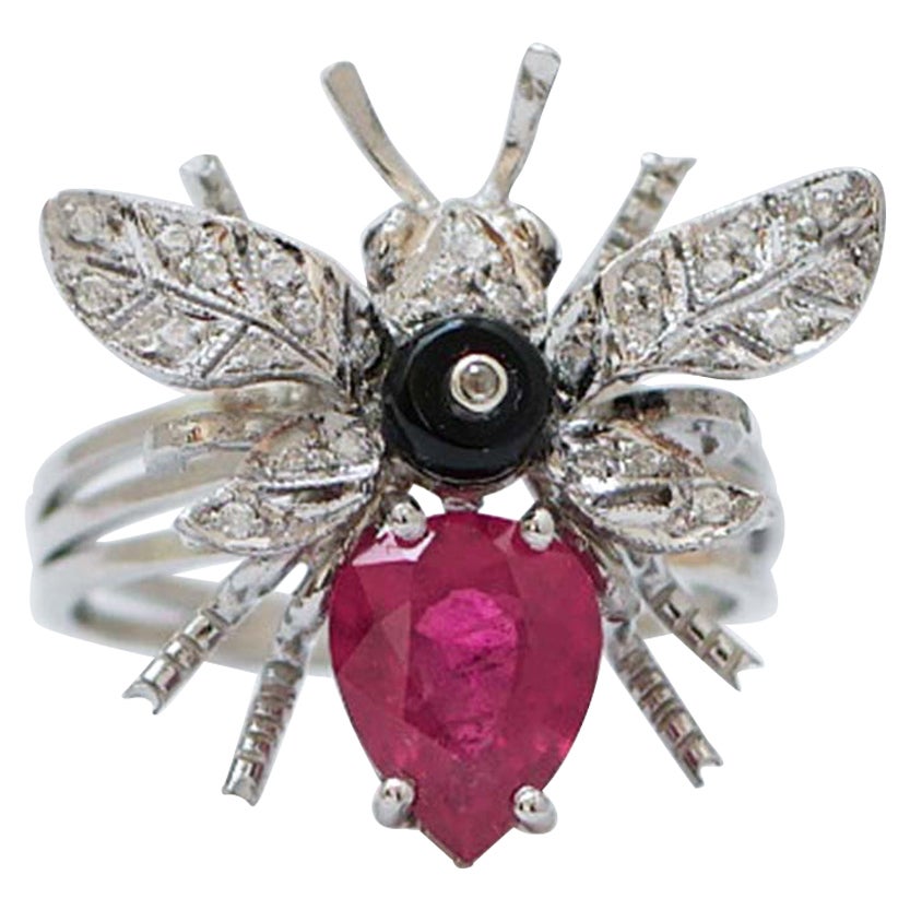 Rubino, granati, diamanti, onice, anello di platino.