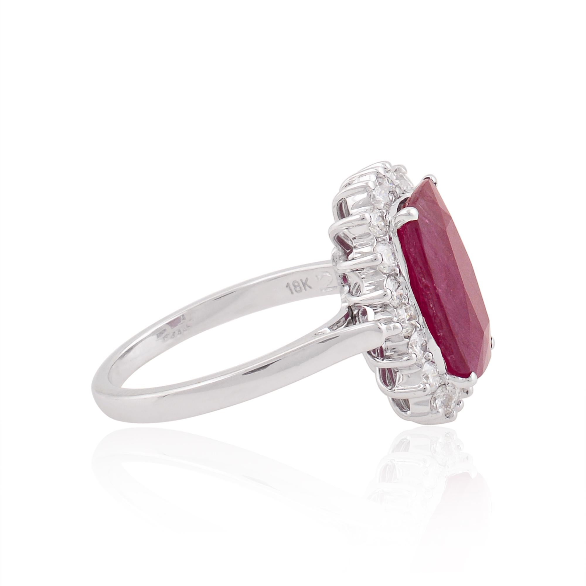 Surrounding the ruby is a sparkling halo of pave-set diamonds, delicately arranged to enhance the brilliance and fire of the gemstone. These dazzling diamonds create a mesmerizing contrast against the rich red hue of the ruby, adding a touch of