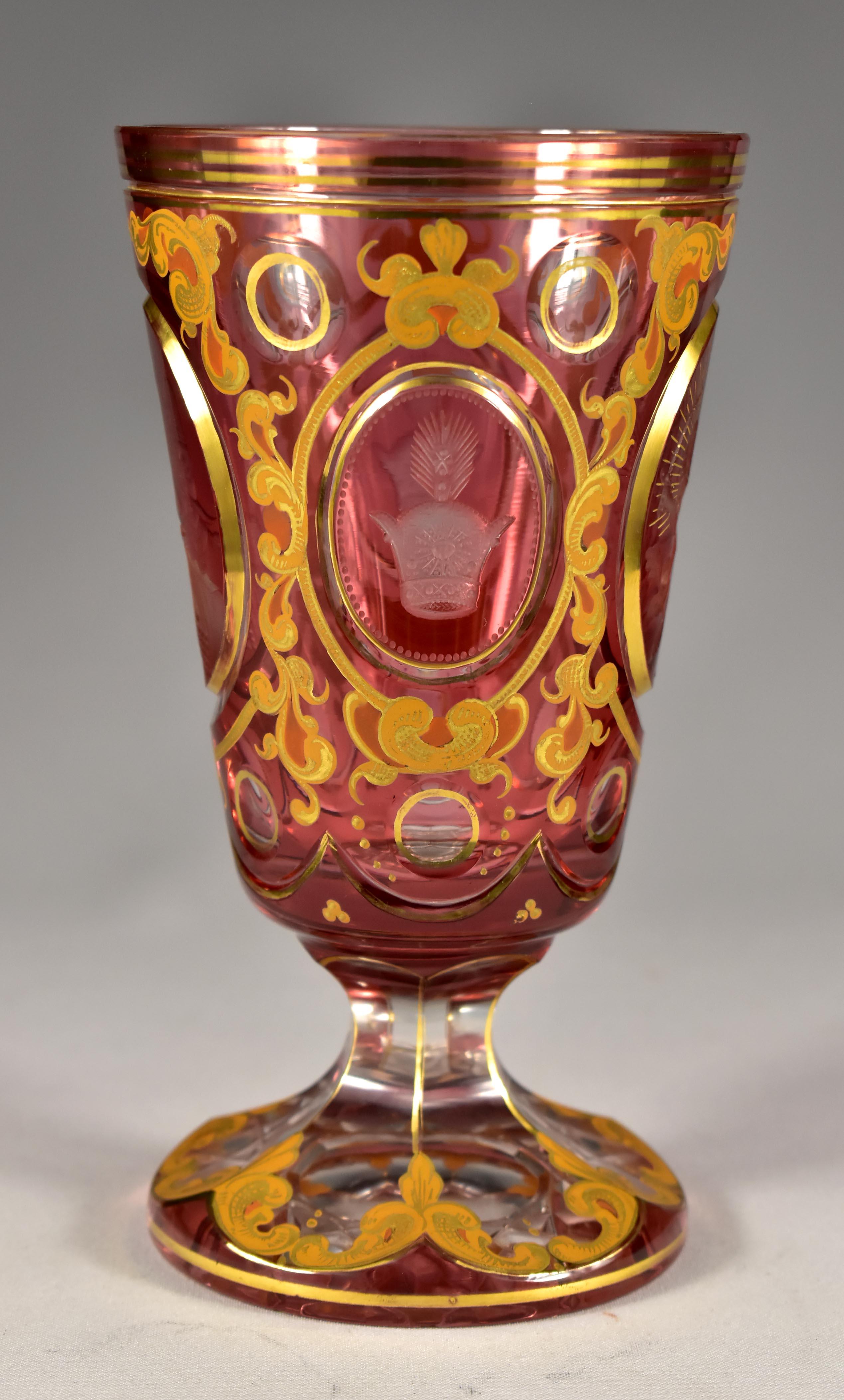 Overlay glass ruby goblet, cut, engraved and painted.It is probably the work of Bohemian glass masters from the first half of the 20th century. It is a portrait of the Shah - Mozaffar ad-Din Shah Qajar, probably made for some anniversary or a