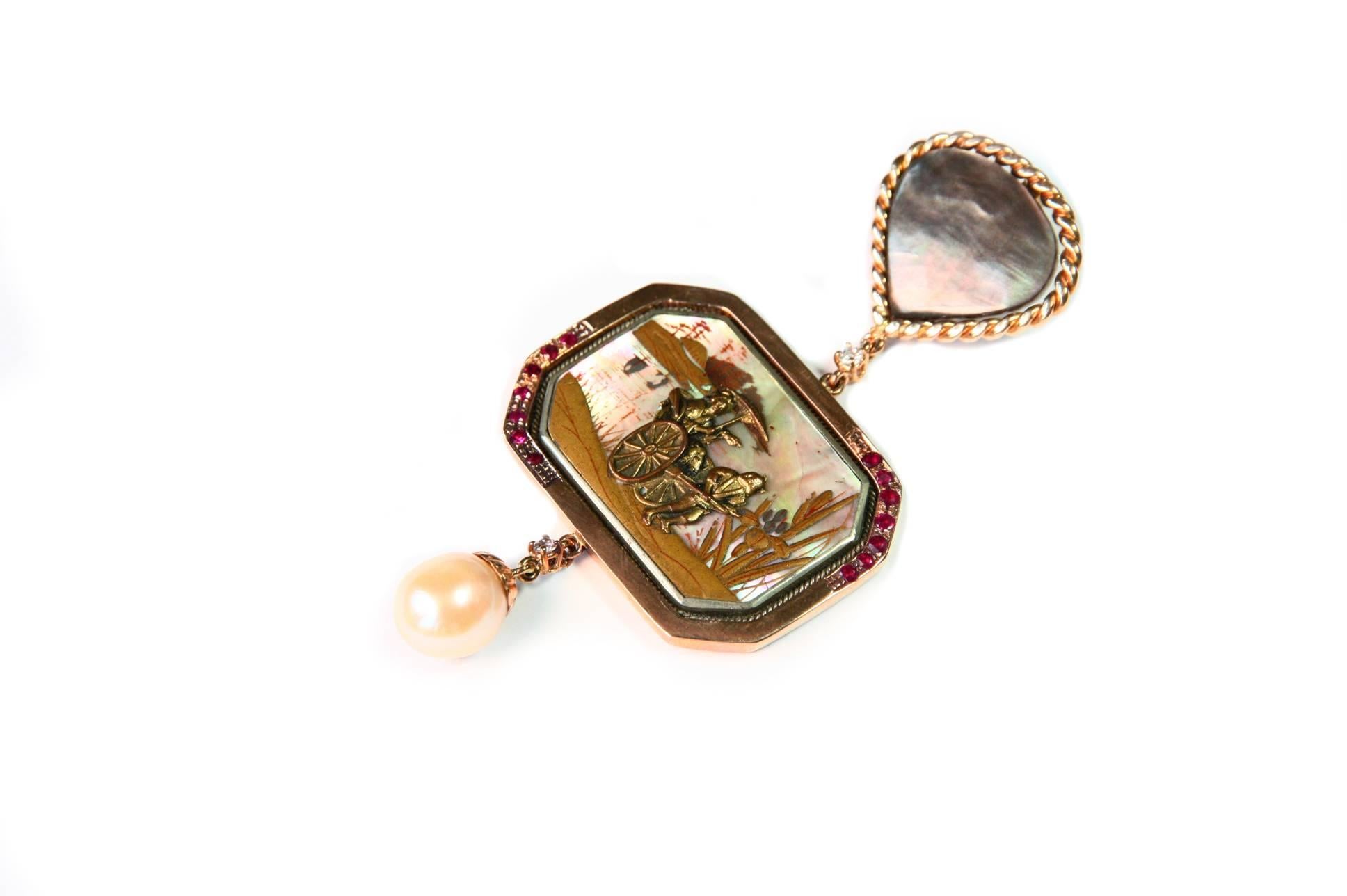 Fantastic pendant made with  antiques Japanese miniature on mother of pearl fine designed with japanies landscape and natural details of lake stage, a geisha figure under the umbrella, Fuji mountain on the back everything  on relief, ruby, 18kt rose