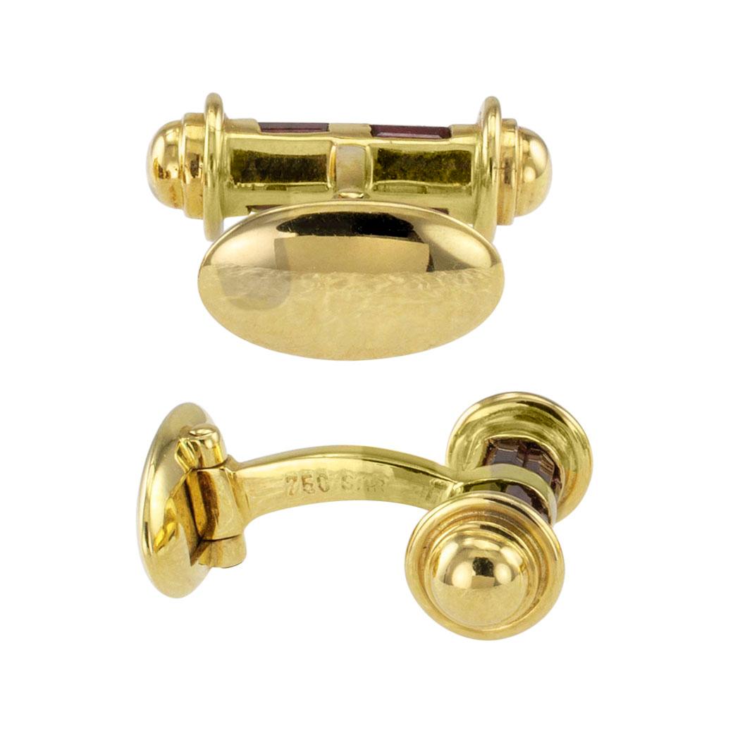 Estate 1990s ruby and gold cufflinks. Elegant and masculine, the baton-shaped designs feature twin rows of channel-set ruby baguettes mounted in 18-karat yellow gold with ergonomic connectors and hinged backs. Love yourself a little with these