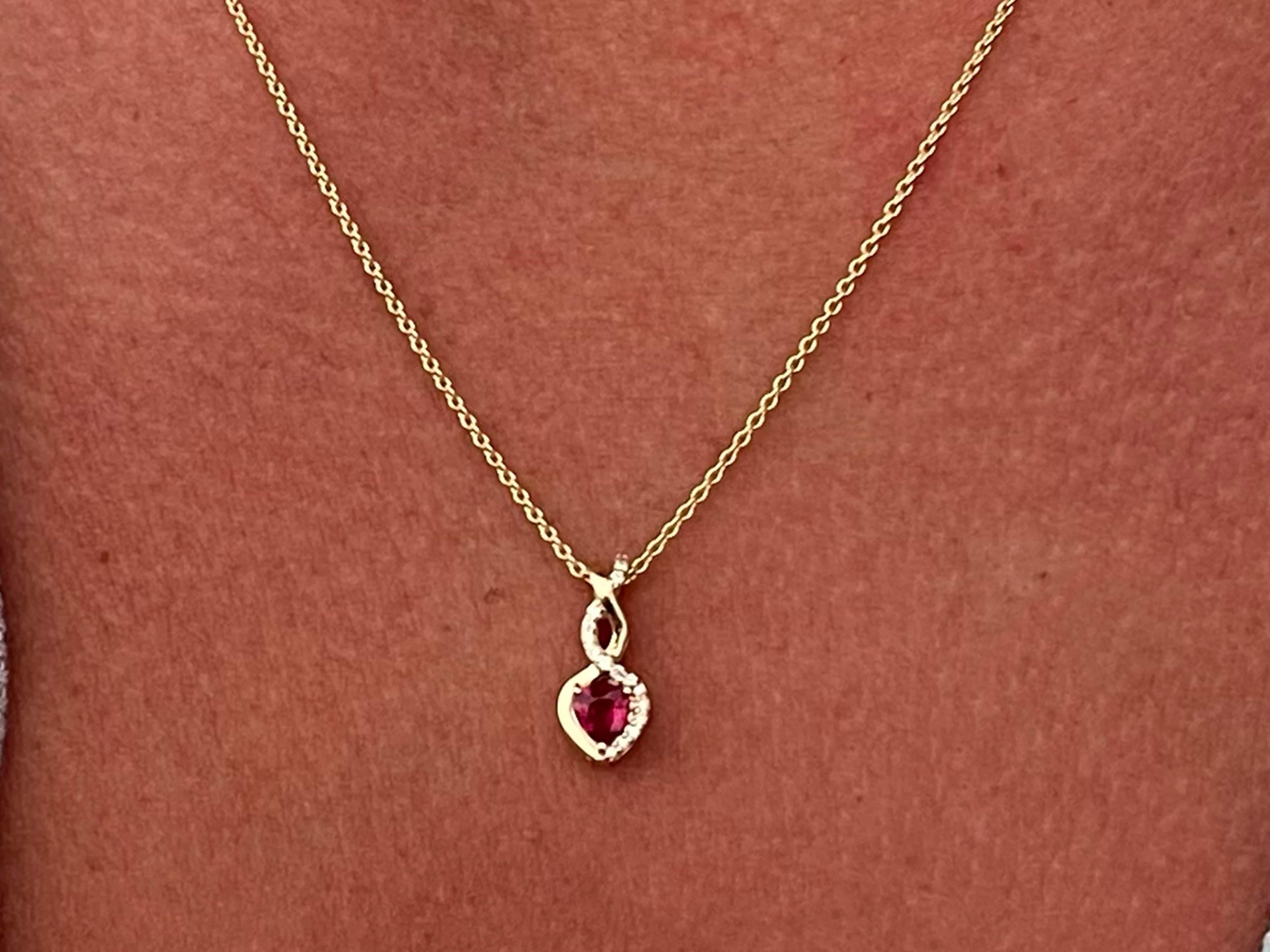 Create a touch of magic wearing this lovely ruby and diamond pendant for women featuring a 0.25 carat heart shaped red ruby set in luxurious 14k yellow gold. The fashionable twist style is accented with 16 round brilliant diamonds. This beautiful