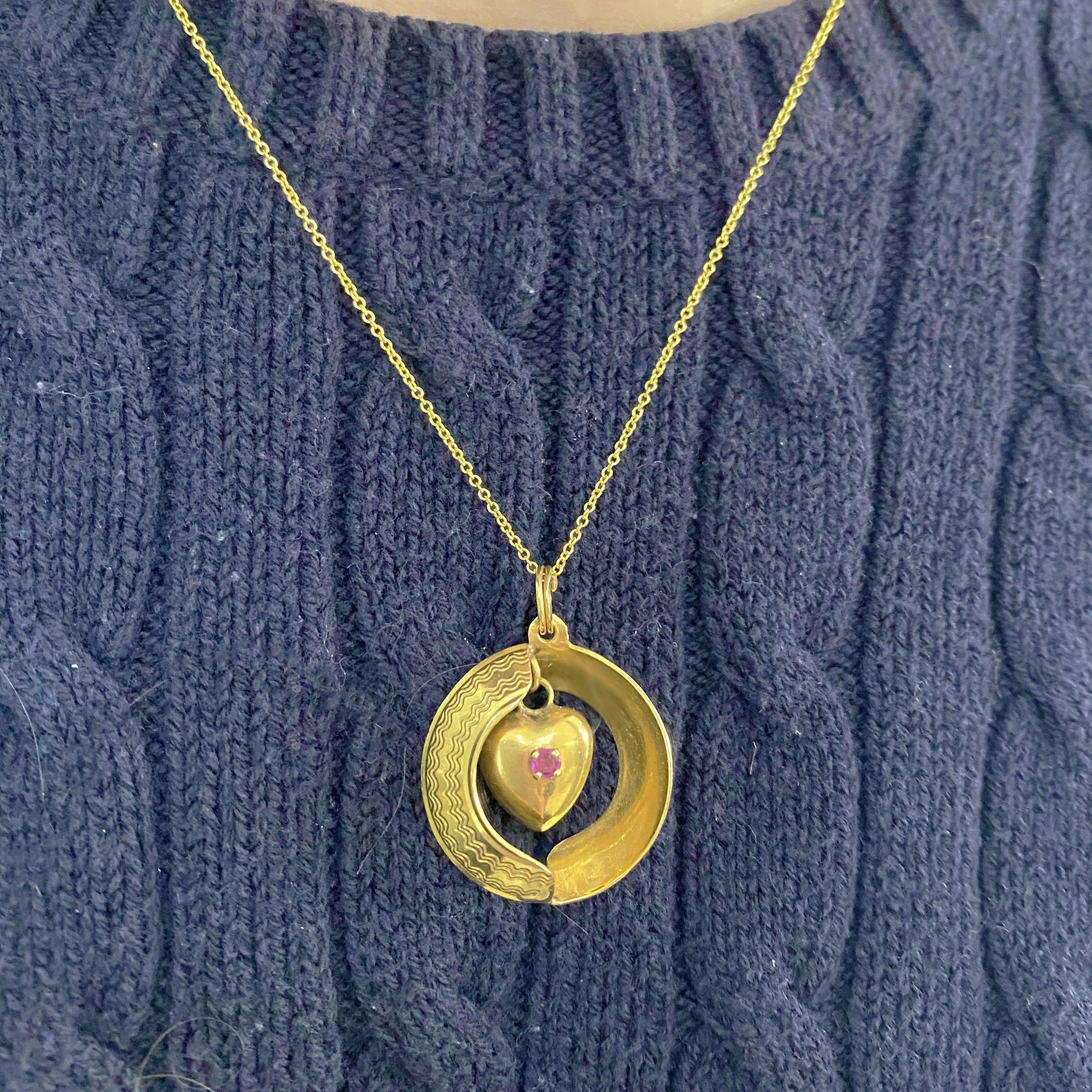 This gorgeous 14k yellow gold reversible ruby and sapphire heart pendant is sure to put a smile on anyone's face!  If you wear it one way, the ruby shows and if you flip it over then the sapphire will show so the actual  hear is the same on both