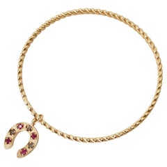 Ruby Horseshoe Charm Twisted Gold Bangle Bracelet