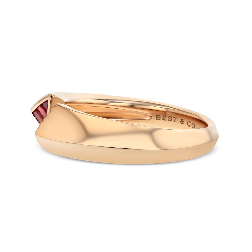 This contemporary piece is composed of 6 baguette cut rubies and 18 karat rose gold. Its knife edge style and open ended band, which leads to two opposing triangles of rubies, allows for a unique geometric design and overall creates a sleek modern