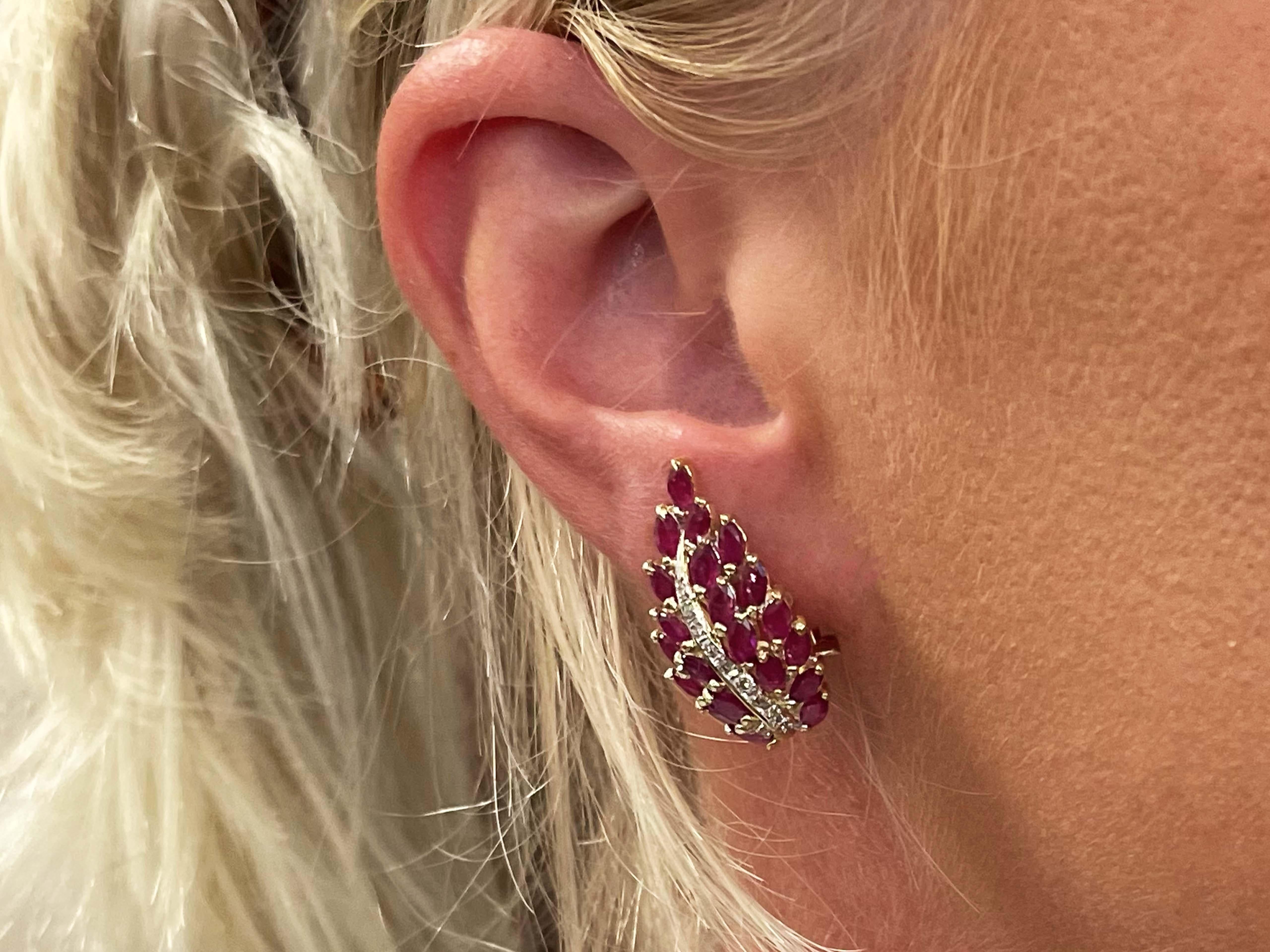 Earrings Specifications:

Metal: 14k Yellow Gold

Earring Diameter: 28 mm x 15 mm

Total Weight: 7.9 Grams

Ruby Setting: Prong

Ruby Total Count: 42

Ruby Carat Weight: ~2.00 carats

​​Diamond Color: H-I
​
​Diamond Clarity: SI
​
​Diamond Count: 20