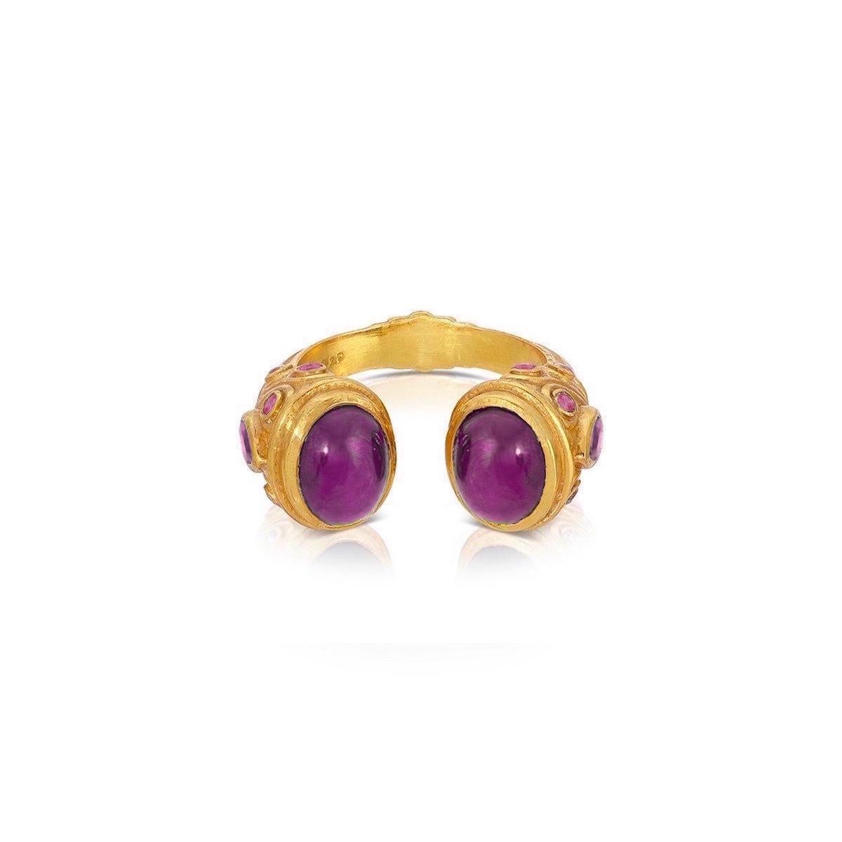 A contemporary interpretation of the opulent jewelry style of the Moguls... A fabulous Ruby ring featuring an open ended band tipped with fiery Rubies and pear shaped Rubies on the side of the ring. This beautiful ring features 6.75 Carats of Rubies