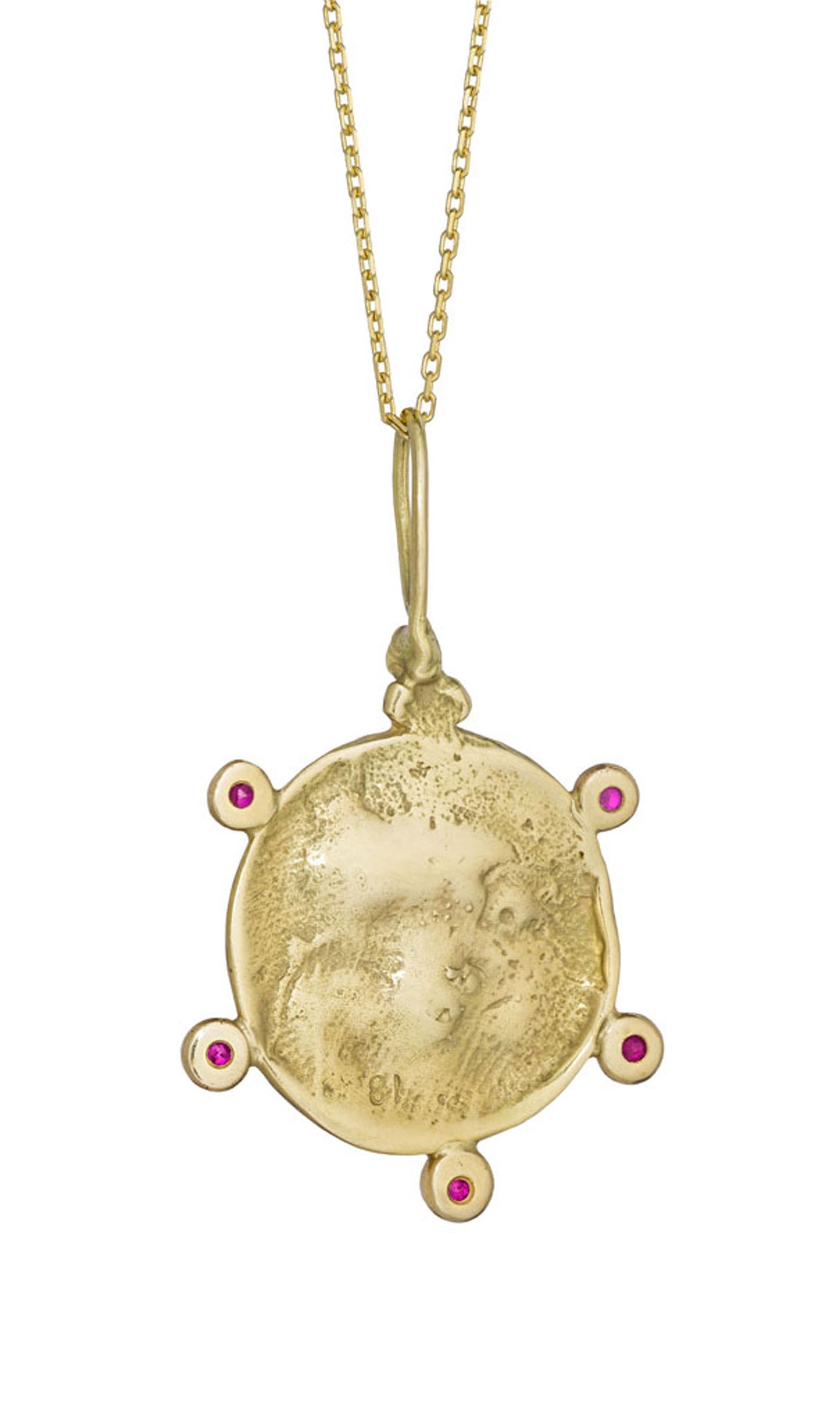 The classic Moon Face pendant captures feminine celestial energy. As the moon governs the movements of the tides in and out, in her dance through the heavens she also represents the ebb and flow of a woman’s divine force. The Ruby Moon Face Pendant
