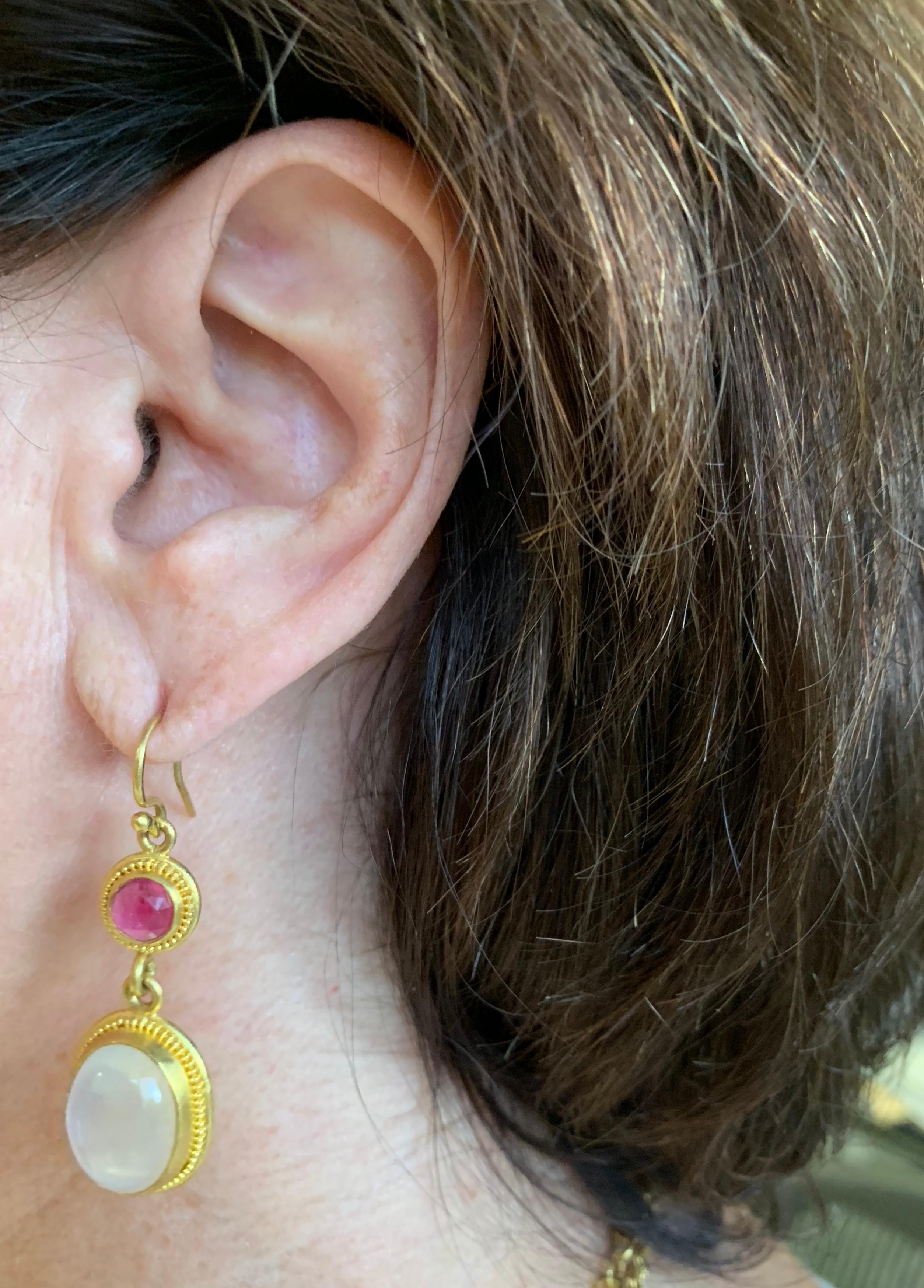 Rose cut Madagscar Rubies 6.5 millimeters  2.80 carats and Sri Lanka Moonstones 15.5 x 11.5 millimeters weighing 17 carats,  set in antique Roman fashion in 22 karat gold with granulation.
Earwire are 20 karat gold.
The earrings are hand crafted in