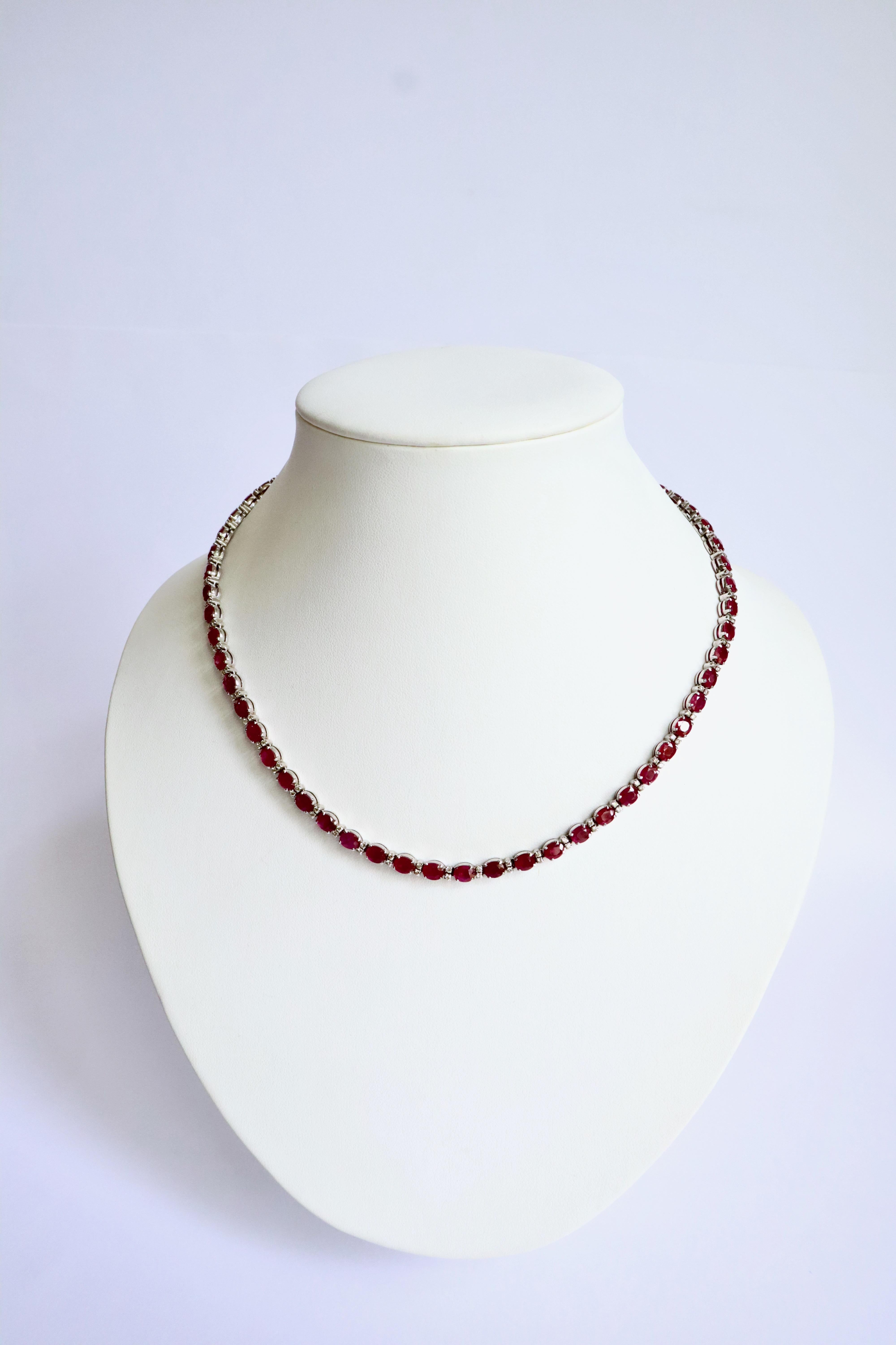 Ruby and diamond line necklace Choker in 18 carat white gold setting.
It is composed of 60 rubies of oval cut alternated with 2 diamonds each diamond weighing approximately 0.01 carat.
Total weight of the 60 rubies: 25.9 carats.
Total weight of the