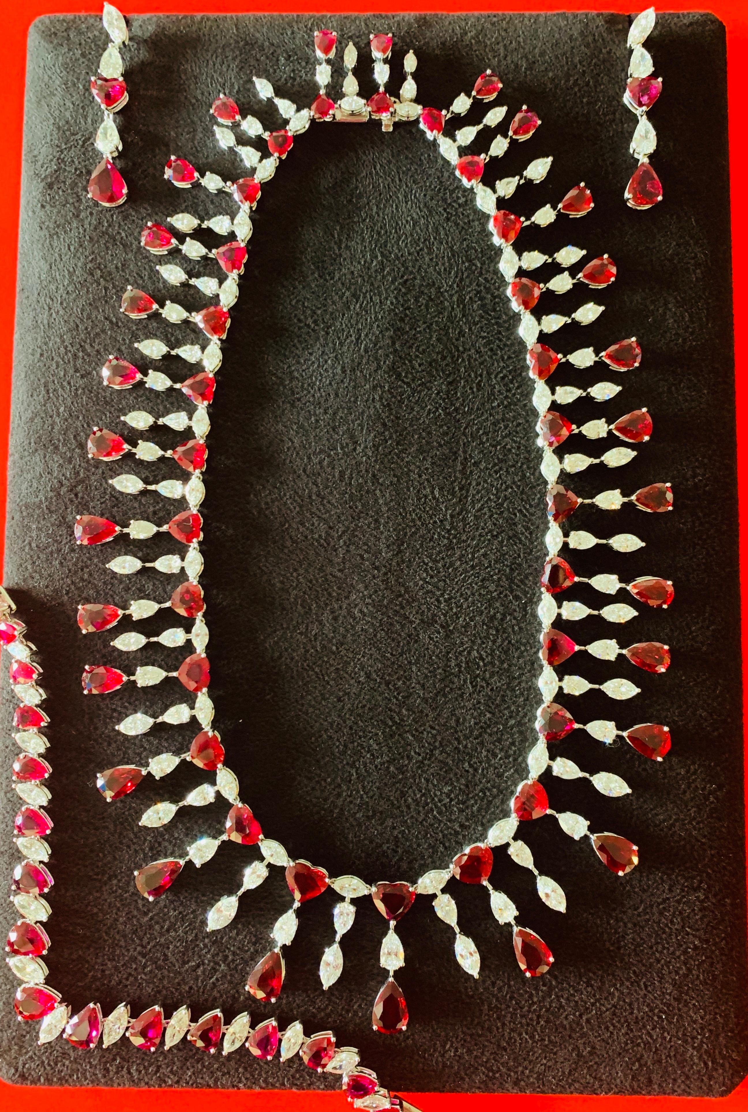 Exceptional beauty and exquisite elegance. This ruby ( no heat ) and diamond necklace includes a pair of earrings and a bracelet.
The details are as follows ; 
Heart shape and Pear shape ruby weight : 125 carat / 74 stones ( no heat rubies)
Marquise