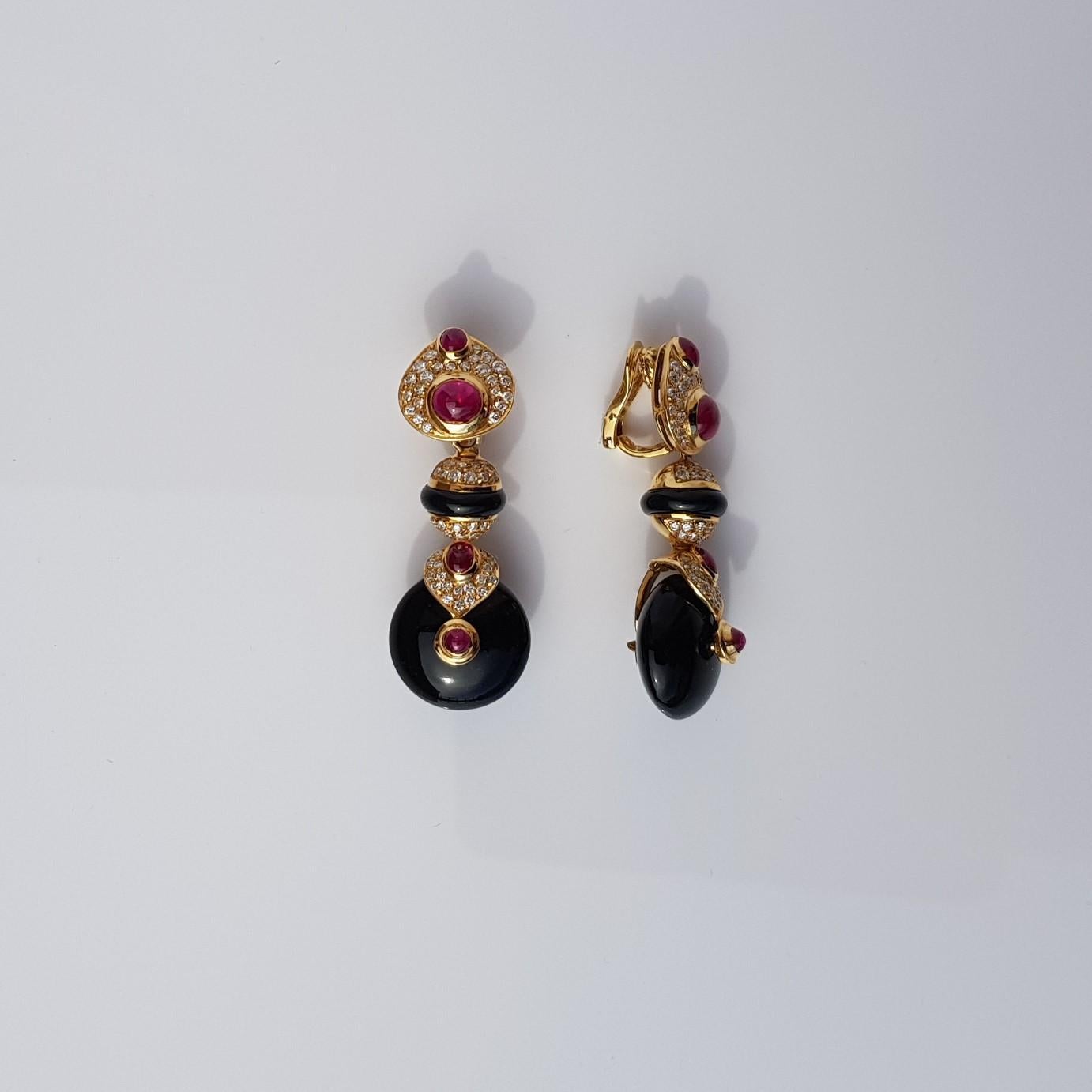 The earrings are set in 18KT yellow gold  embellished by 1.90 carats of diamonds, 4.50 carats of rubies and by 3.18 grams of onyx