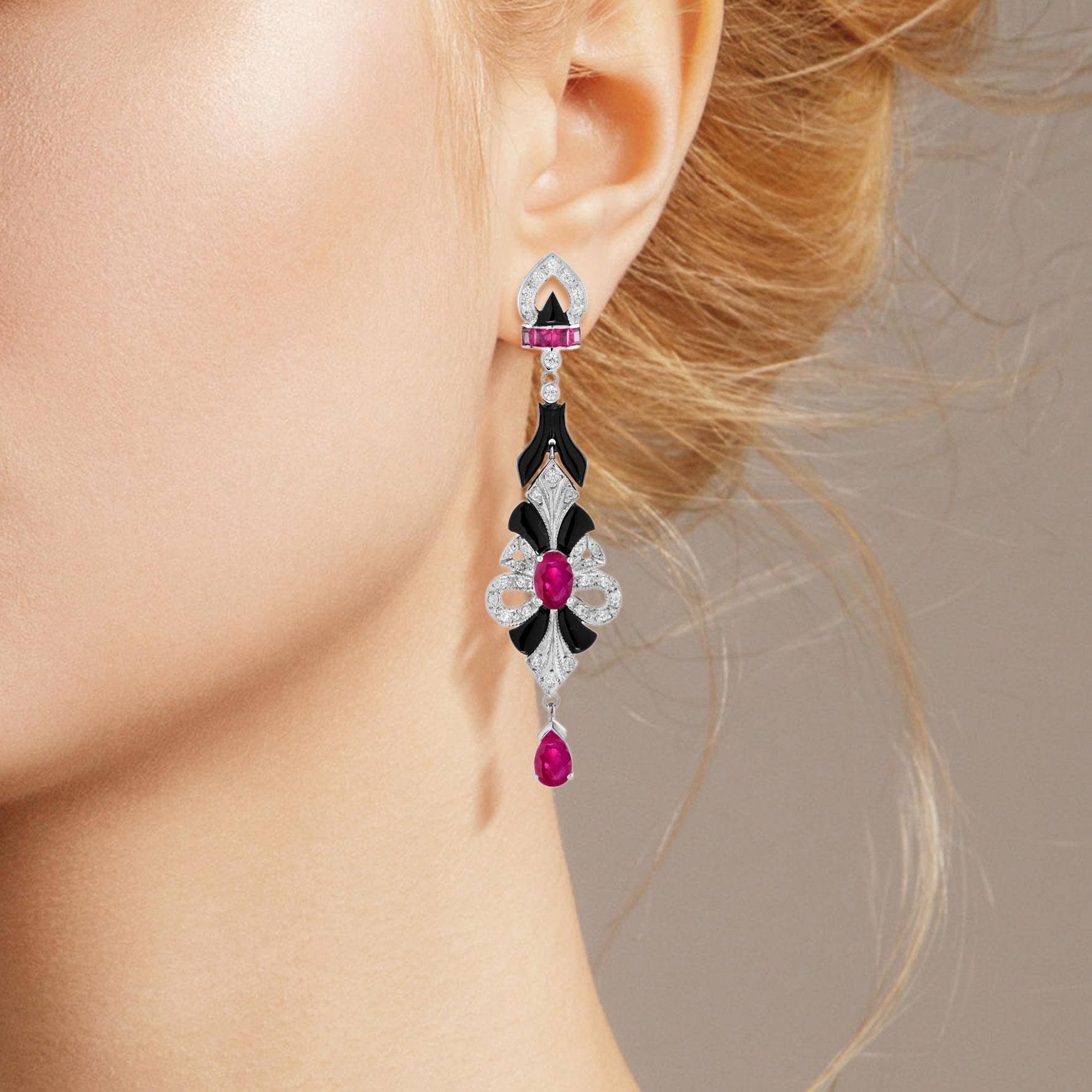 A dramatic and unusual pair of antique design eardrops anchored by a ruby centered, ruby drop, with black onyx and diamond accent. This charming piece is a winsome adornment perfect to mark a milestone occasion. 

Earrings Information
Style: Art