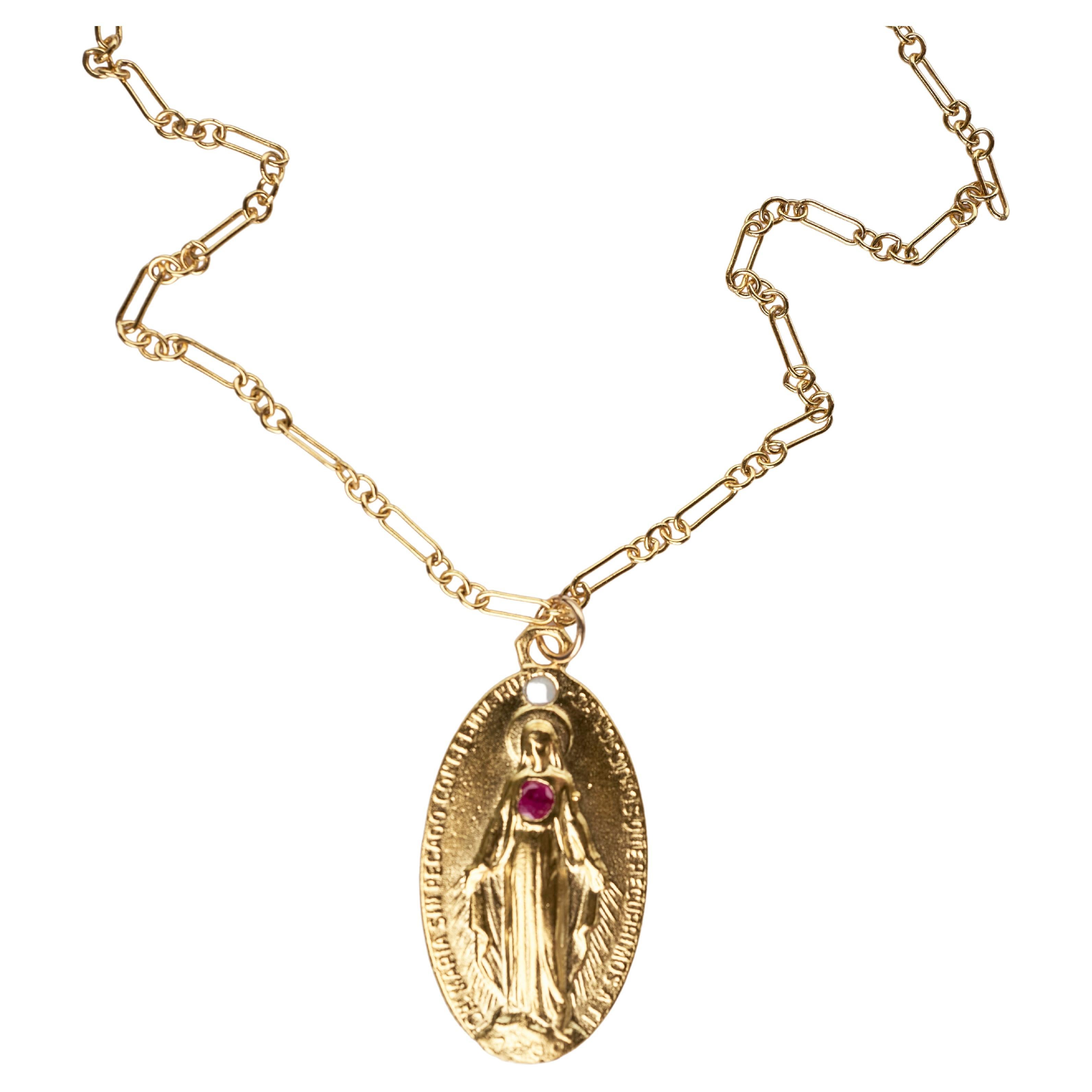 Ruby Opal Medal Virgin Mary Chain Necklace
Designer: J Dauphin
14k Gold Plated Brass Medal and Gold Filled Chain

Symbols or medals can become a powerful tool in our arsenal for the spiritual. 
Since ancient times spiritual pendants, religious