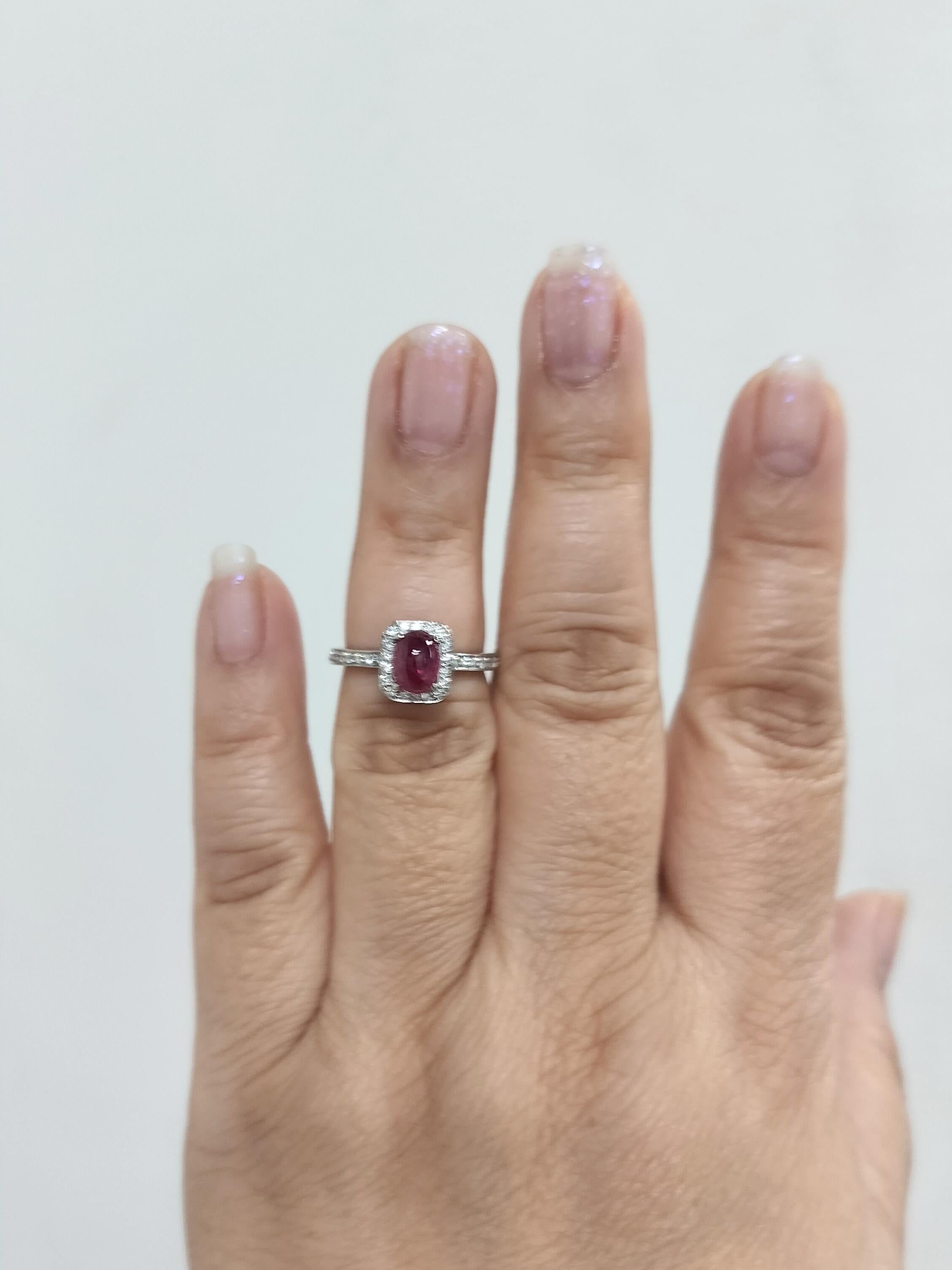 Beautiful 1.61 ct. red ruby oval cabochon with 0.18 ct. white diamond rounds.  Handmade in platinum.  Ring size 6.5.