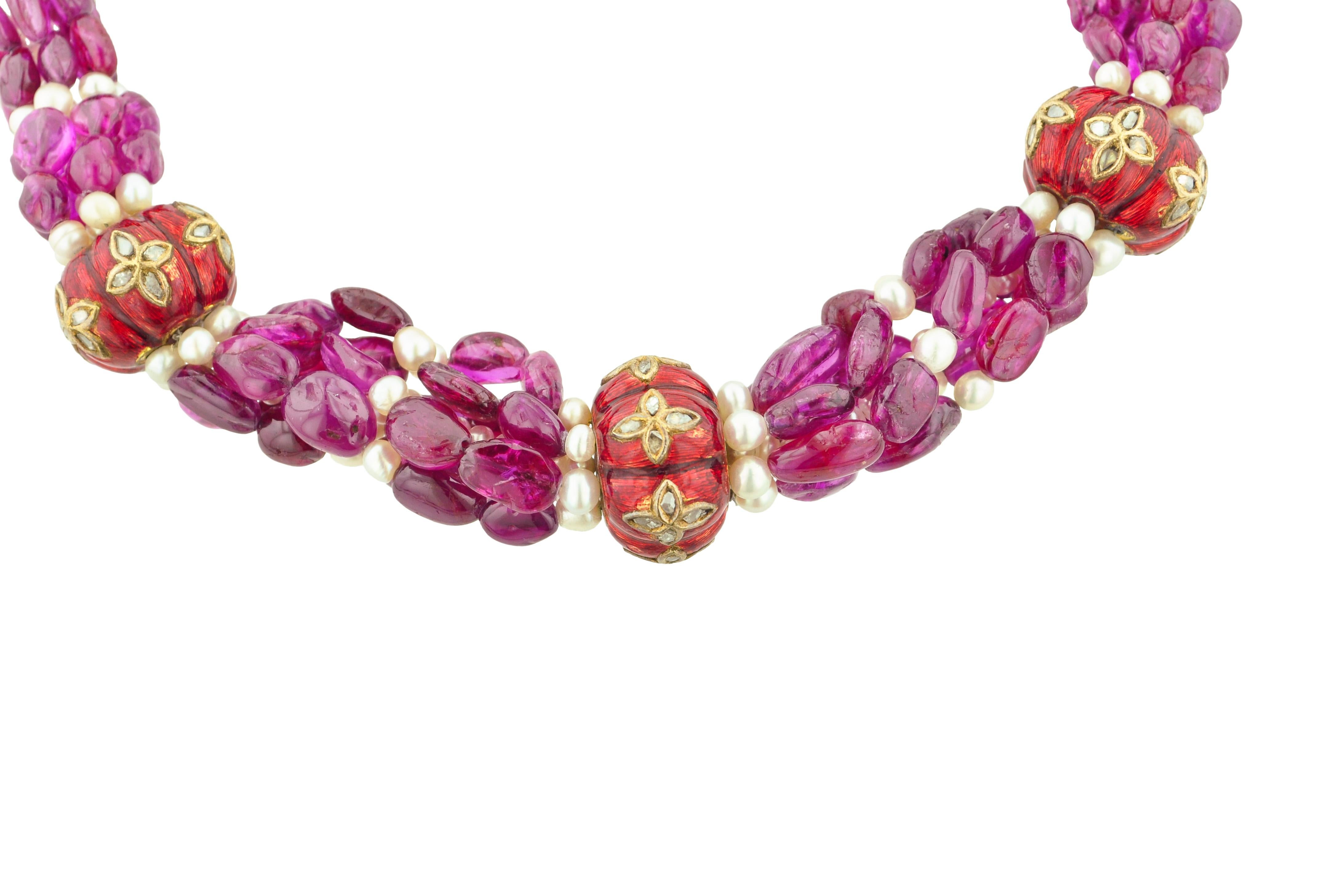 Indian style choker necklace featuring ruby beads, cultured pearl beads, and Indian beads composed of enamel and gold.

There are over 350.00 carats of rubies.

Length: 16 1/2 inches