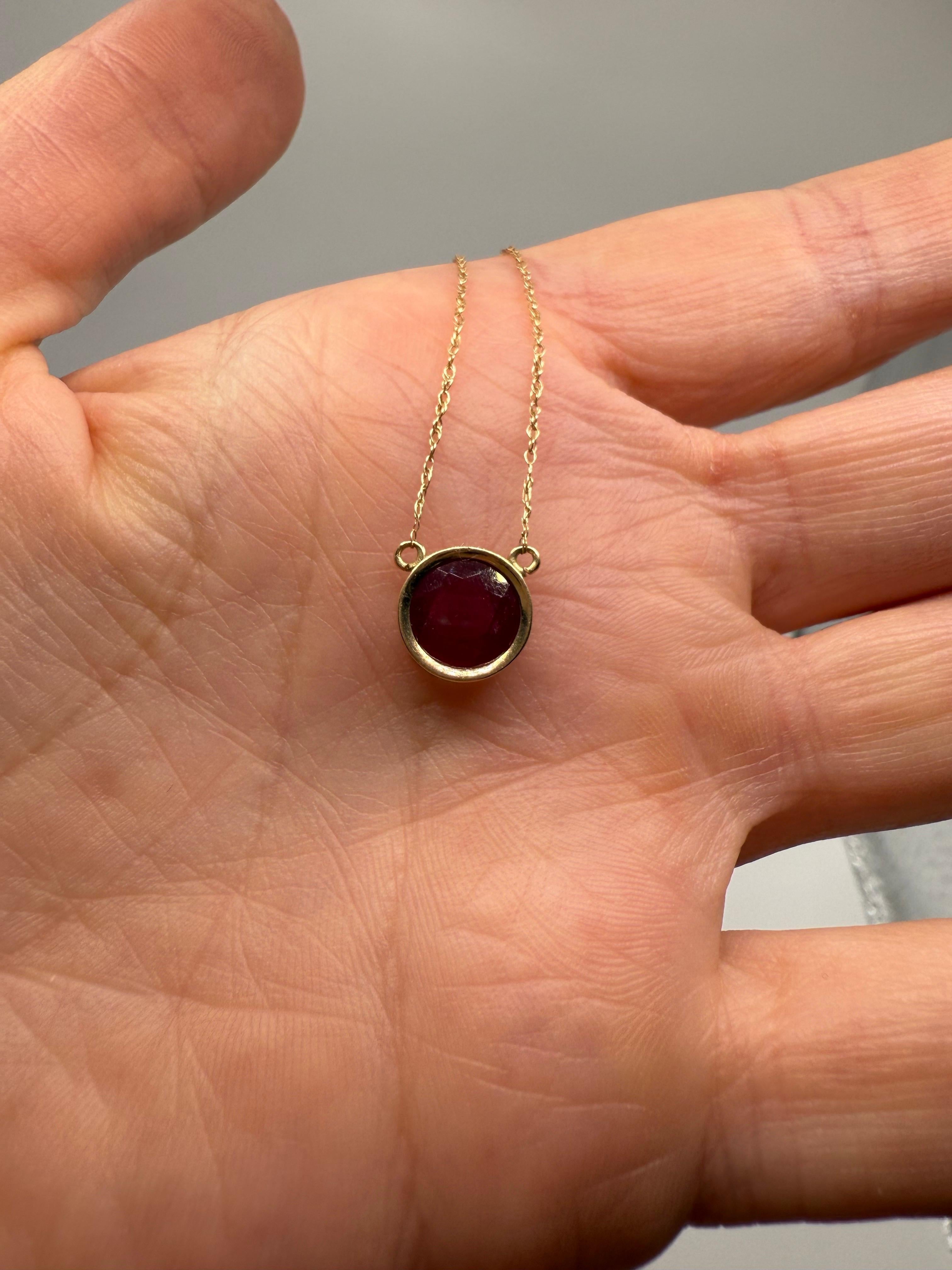 Solitaire 8mm ruby in 10KT solid yellow gold, very modern pendant necklace with a large ruby, the ruby is natural and has a wine color, certified as Pinkish Red color ruby and moderately included. Inclusions are normal for all rubies, this one