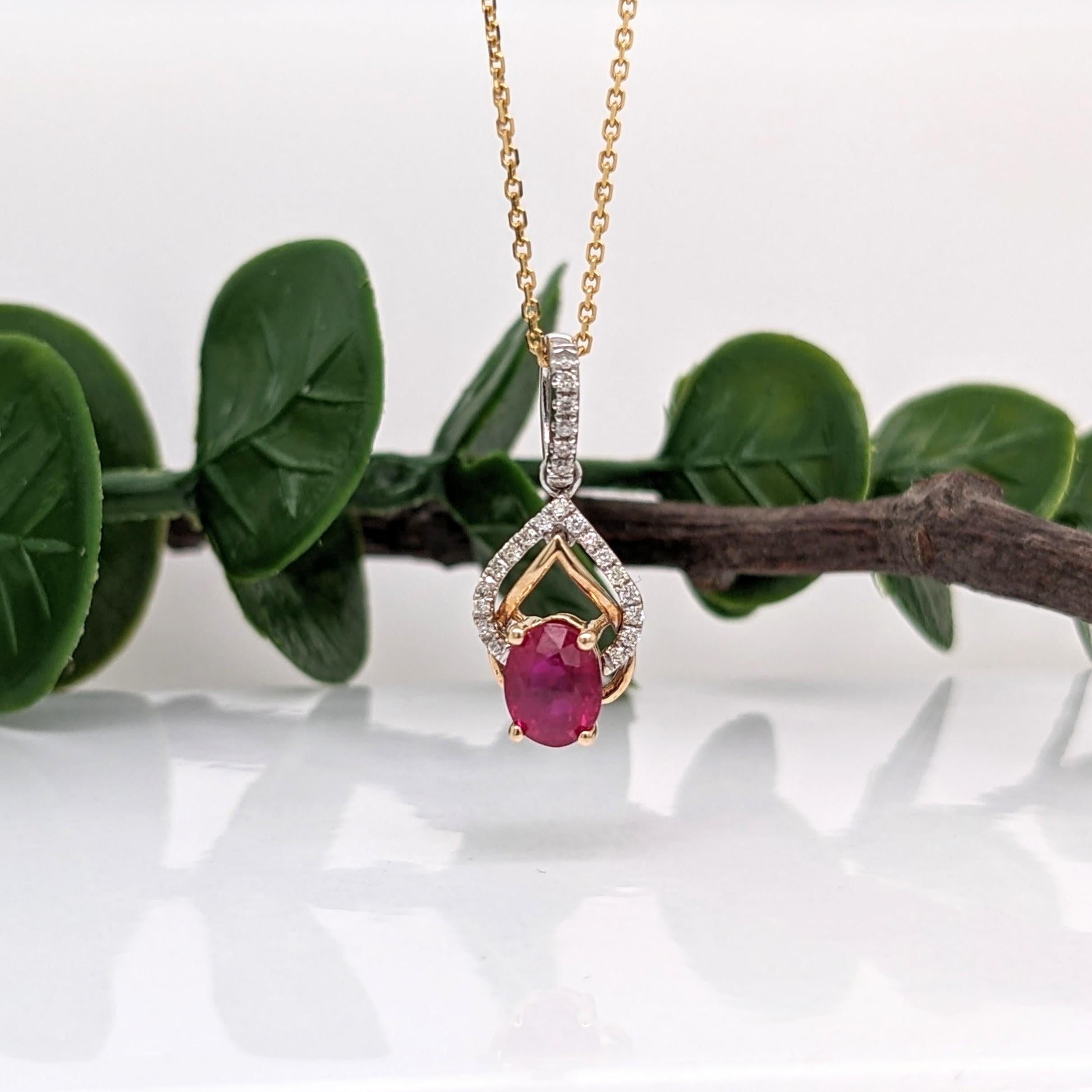 This gorgeous ruby pendant is a timeless statement piece. It is crafted with a 6x4mm oval natural ruby and encircled with natural diamond accents, all set in solid 14K dual yellow and white gold. With its minimalist design and stunning July