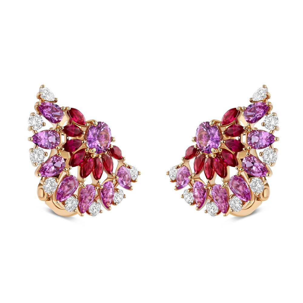 These ruby, pink sapphire, and diamond earrings are stunning and extraordinary. Each earring features 8 glorious red rubies, 8 pink sapphires, and 8 white diamonds intertwined into a semicircle. Vibrant colors and bespoke design make these earrings