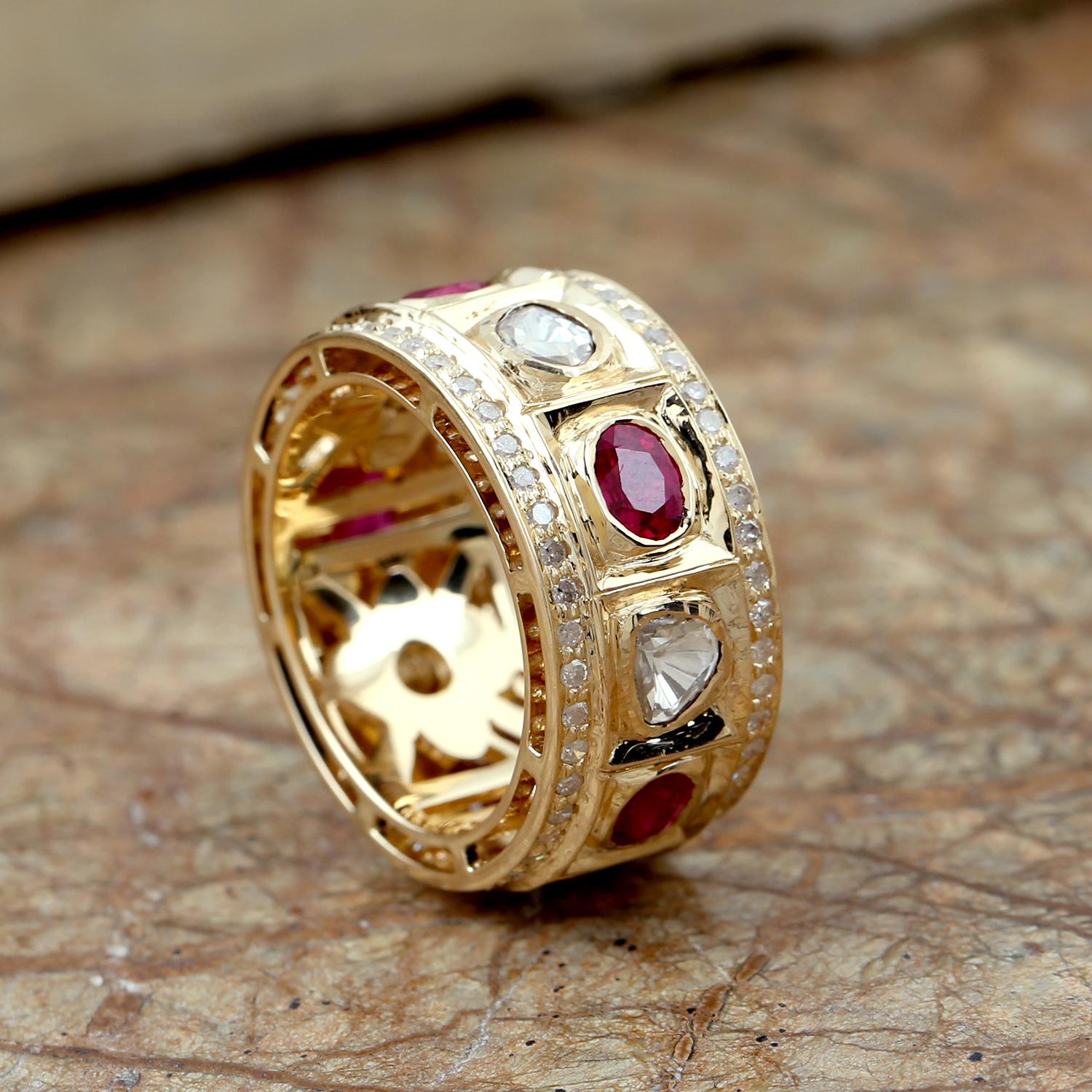 This beautiful band ring is made from 18k yellow gold and features a row of rubies and polki diamonds with a set of pave diamond . The rubies are a deep, rich red color and are interspersed with sparkling polki diamonds, which add a touch of shine