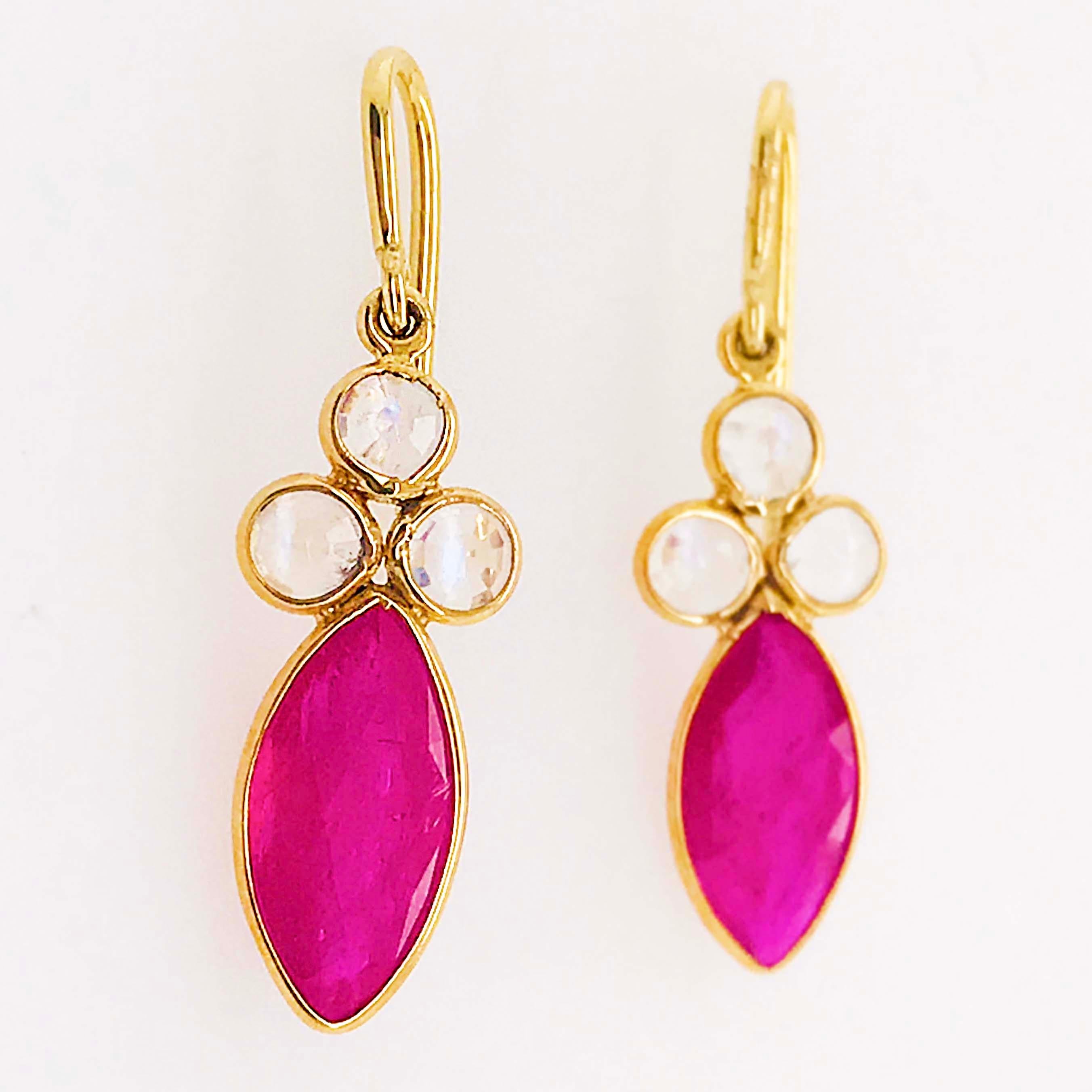 Bold & Beautiful, natural ruby and genuine rainbow moonstone designer earrings! These Tresor original designer earrings are vibrant and striking. The earrings have a marquise shaped, bright ruby gemstone set in a rich 18 karat yellow gold bezel. The
