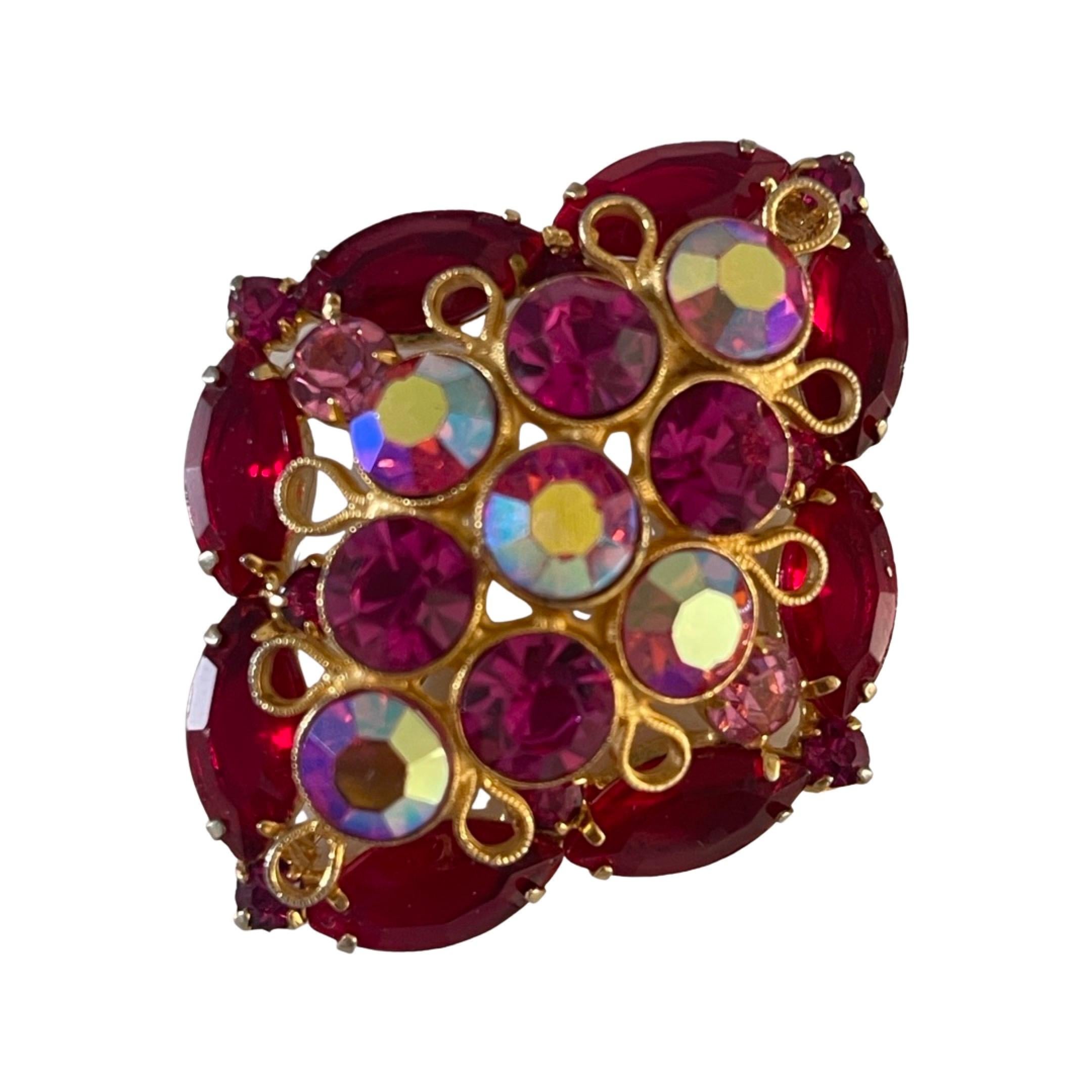 Domed shape brooch is embellished with marquise cut ruby red rhinestones, round-shaped rose pink rhinestones, round-shaped aurora borealis rhinestones, and lastly the four tiny square red rhinestones that compliment the four edges of the brooch. 