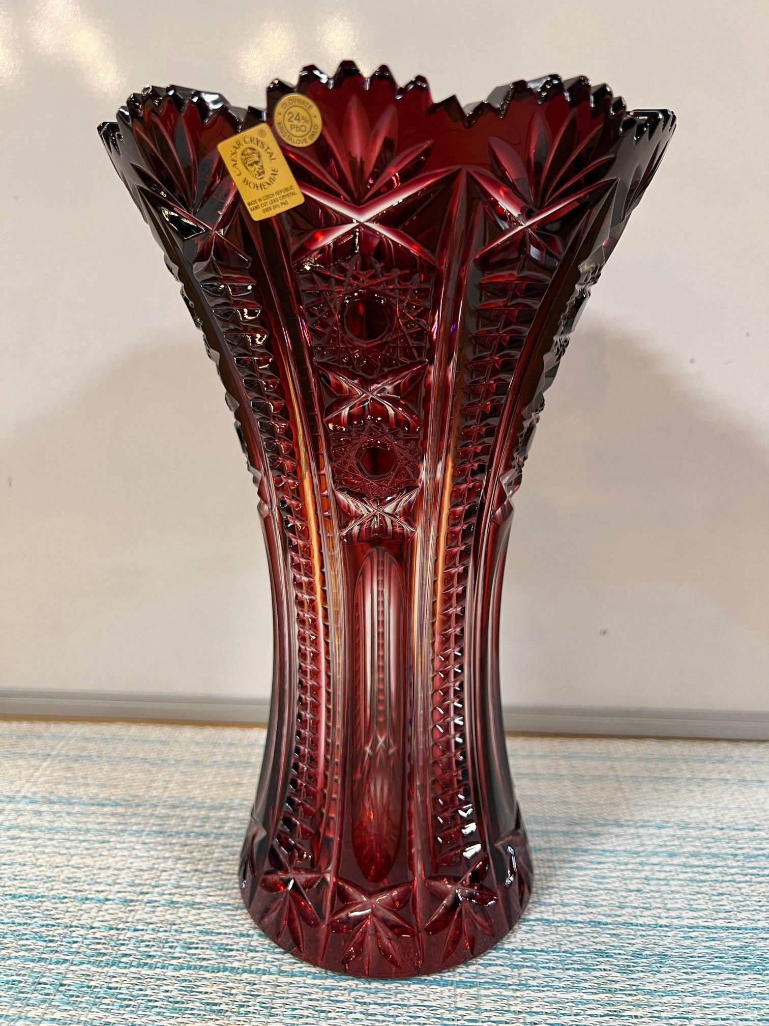 Stunning ruby red hand cut lead crystal vase created as a work of art by the hands of the finest Czech glass workers. The Caesar Crystal Company in the Czech Republic has been selling hand cut lead crystal pieces since 1861 and is known as one of