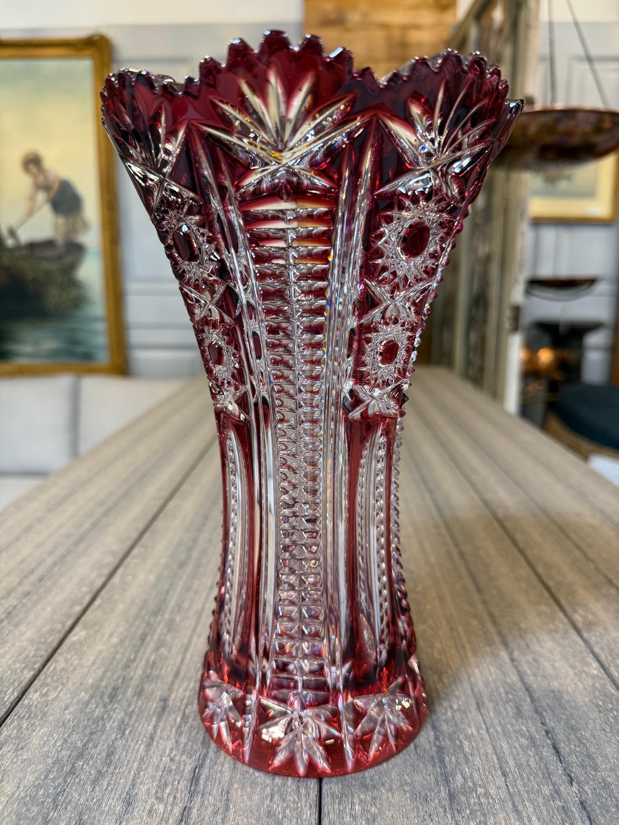 Stunning ruby red hand cut lead crystal vase created as a work of art by the hands of the finest Czech glass workers. The Caesar Crystal Company in the Czech Republic has been selling hand cut lead crystal pieces since 1861 and is known as one of
