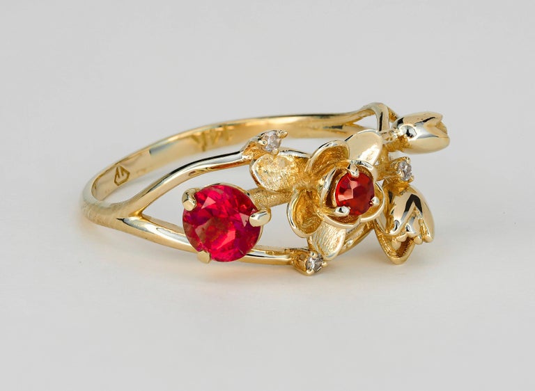 14 kt solid gold Wild Orchid ring with natural ruby, garnet and diamonds. July birthstone. Ruby gold ring. 
Weight approx.  2.30 g. depends from size

Central stone: Natural ruby
Round cut, weight - 0.45 ct in total, 4.5 mm, color - red
Clarity: