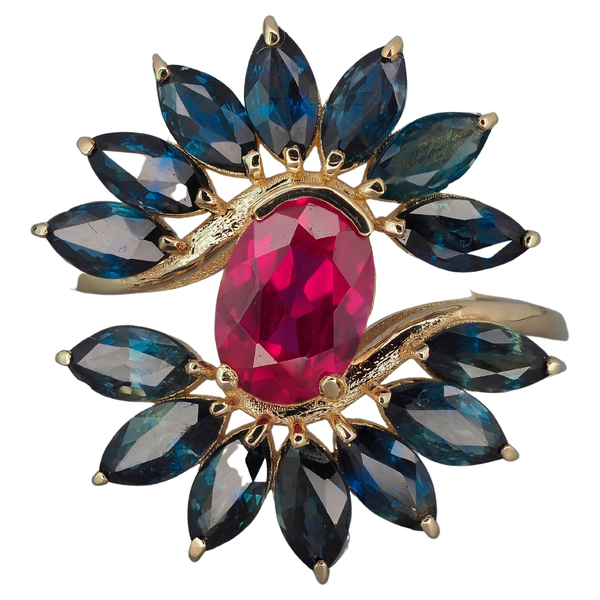 Anillo de rubí y zafiro en oro de 14k.