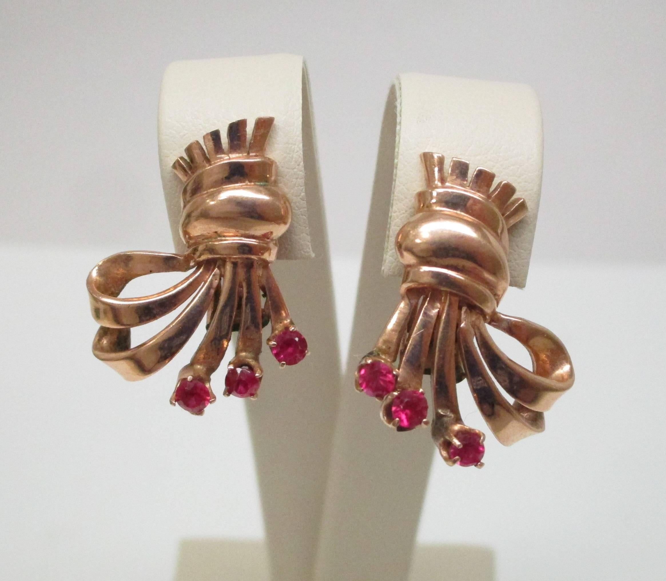 A spray of bright and lively Rubies, gracing rose gold ribbons. These delightful earrings will fast become an everyday favorite. With clip backs, you will be able to just pop these on whenever you get the notion. Super fun and beautiful, you can