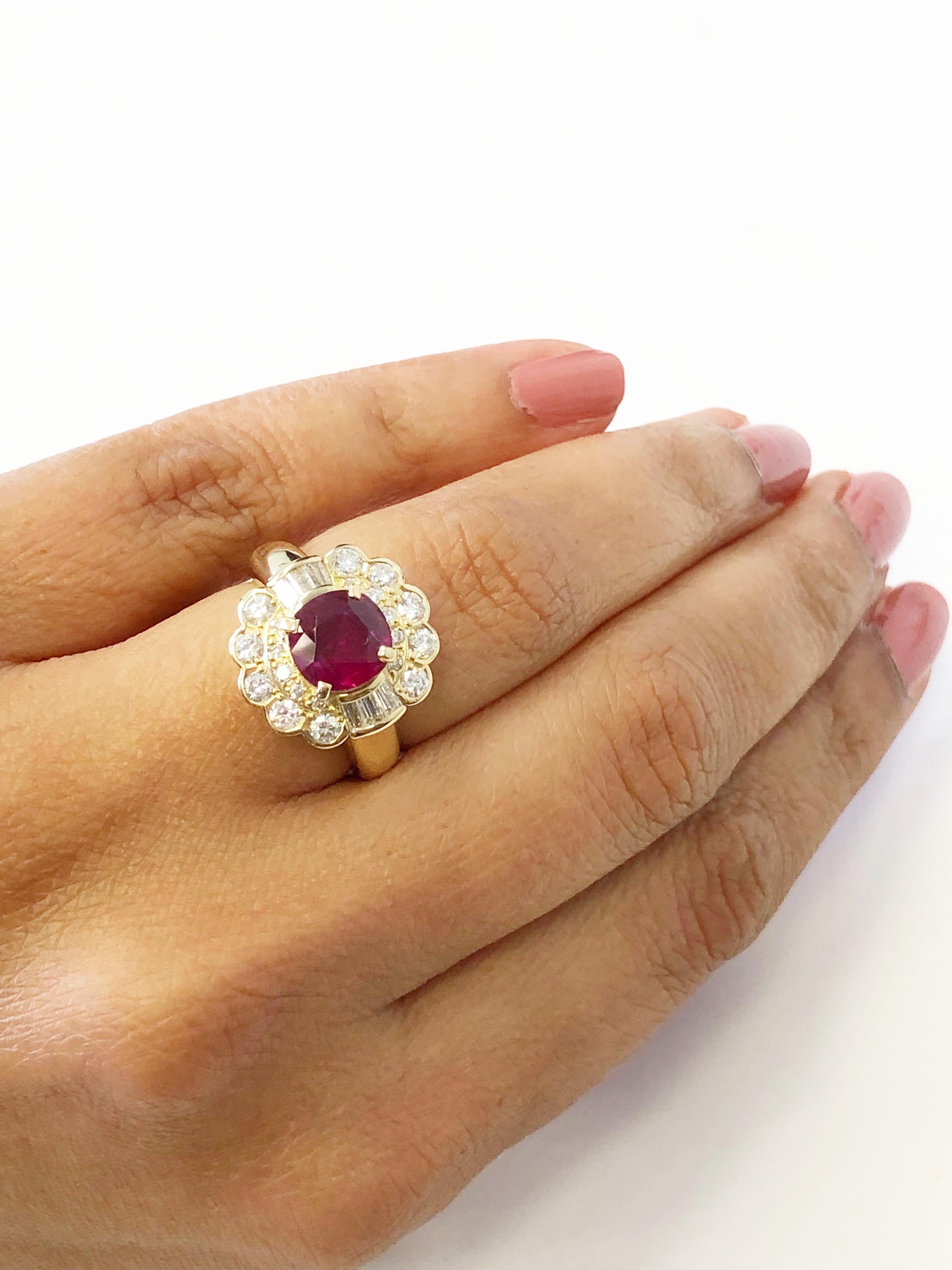 Gorgeous deep red round ruby weighing 2.13 carats with 0.87 carats of good quality white diamond rounds and baguettes.  Handcrafted 18k yellow gold mounting in size 6.  A perfect ring for everyday or a special night out.

