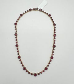 Collana rotonda di rubini in oro giallo 18 carati e rodio nero