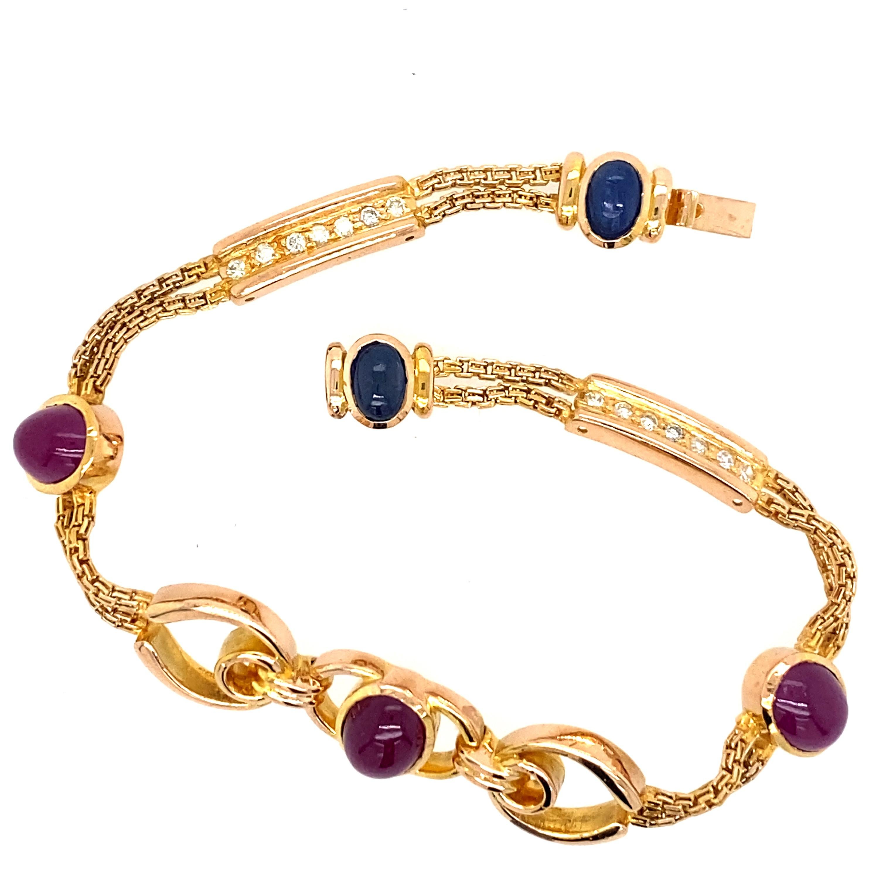 One estate 18 karat yellow gold (stamped 750) bracelet bezel set with three 8.5 x 6mm oval cabochon rubies and two 6x4mm oval cabochon sapphires. There are two bar links, each set with seven round brilliant diamonds, 0.20 carat total weight with