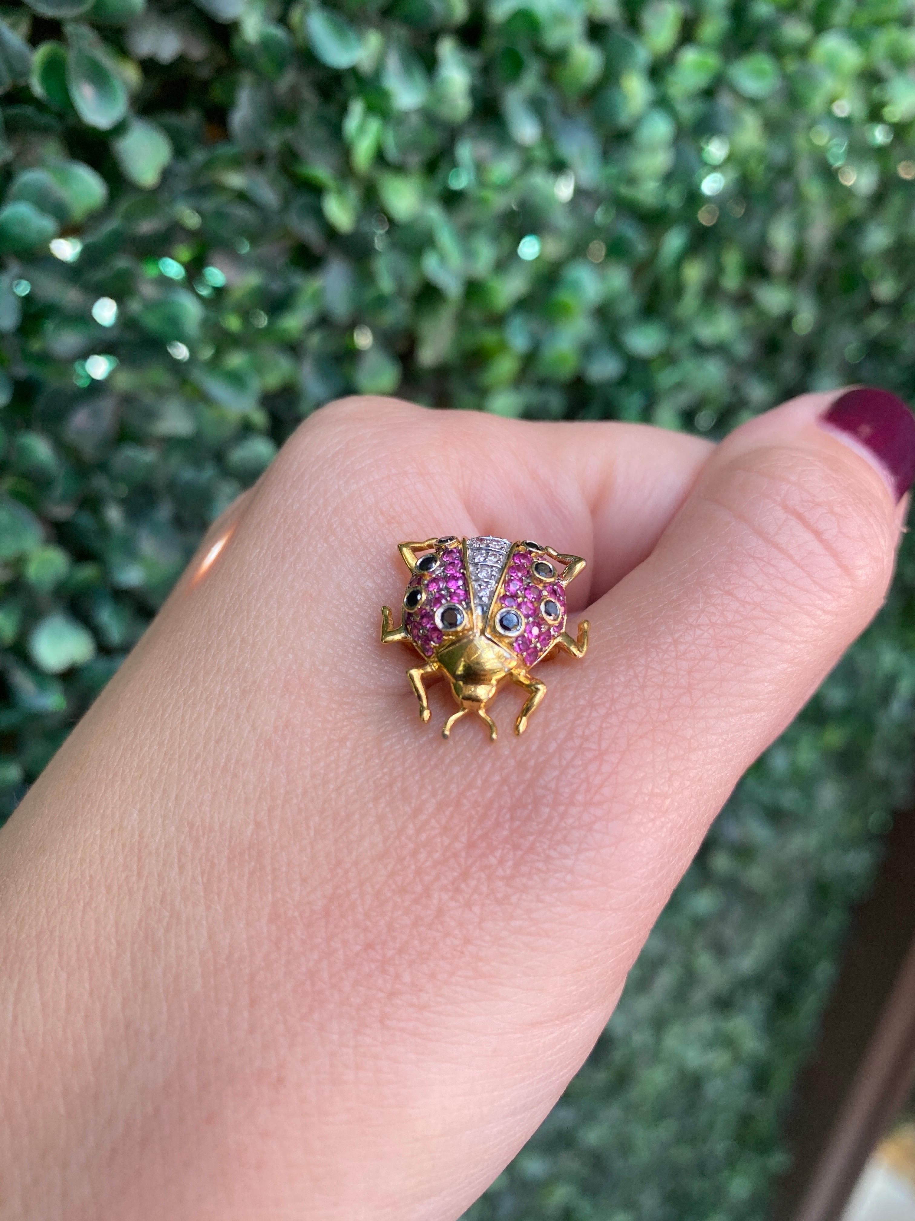 This petite but unique pin features 0.35 carat total weight in round rubies, 0.10 carat total weight in sapphires, and 0.05 carat total weight in round diamonds. Wear alone or gather with the others from our collection for a unique look.