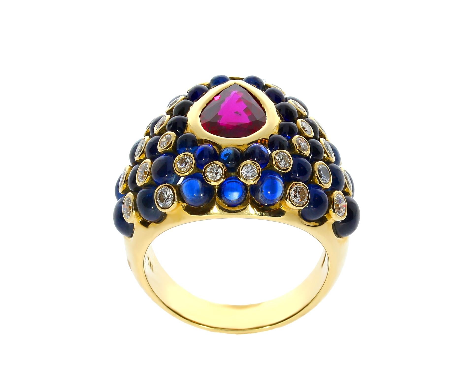 This Chatila 18 carat yellow gold ruby cocktail ring with circular diamond and blue sapphire accents is perfect for any occasion.

Details:

- 32 Diamonds with a total weight of 0.79 carats.
- 1 Ruby with a total weight of 1.46 carats.
- 38