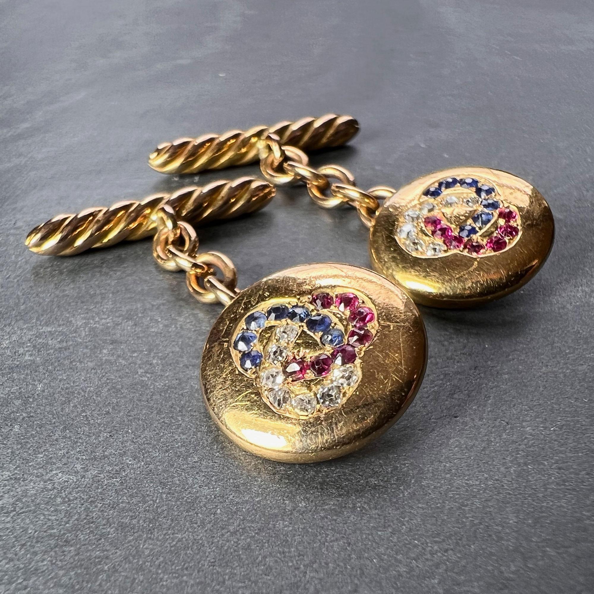 A pair of 14 karat (14K) yellow gold cufflinks each set with a trefoil of seven old or single cut rubies, diamonds and sapphires. Stamped 585 for 14K gold to the reverse. Possibly Russian origin. 

Total gem weights: approximately 0.42 carats