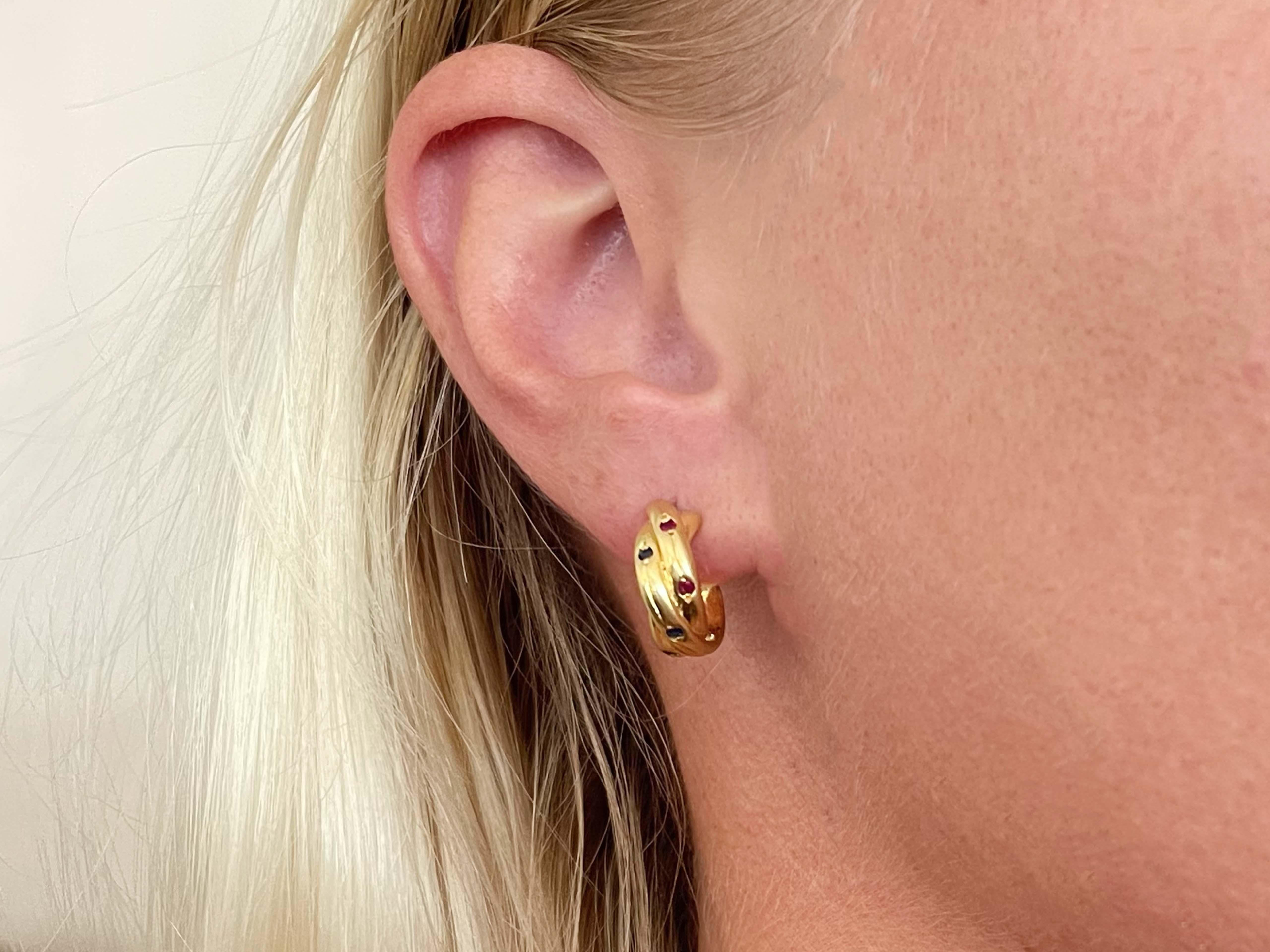 Earrings Specifications:

Metal: 18k Yellow Gold

Earring Diameter: 15.3 mm

Total Weight: 7.4 Grams

Setting: Bezel

Gemstones: 0.04 carats of rubies, 0.06 carats of sapphires and 0.04 carats of emeralds

Stamped: 