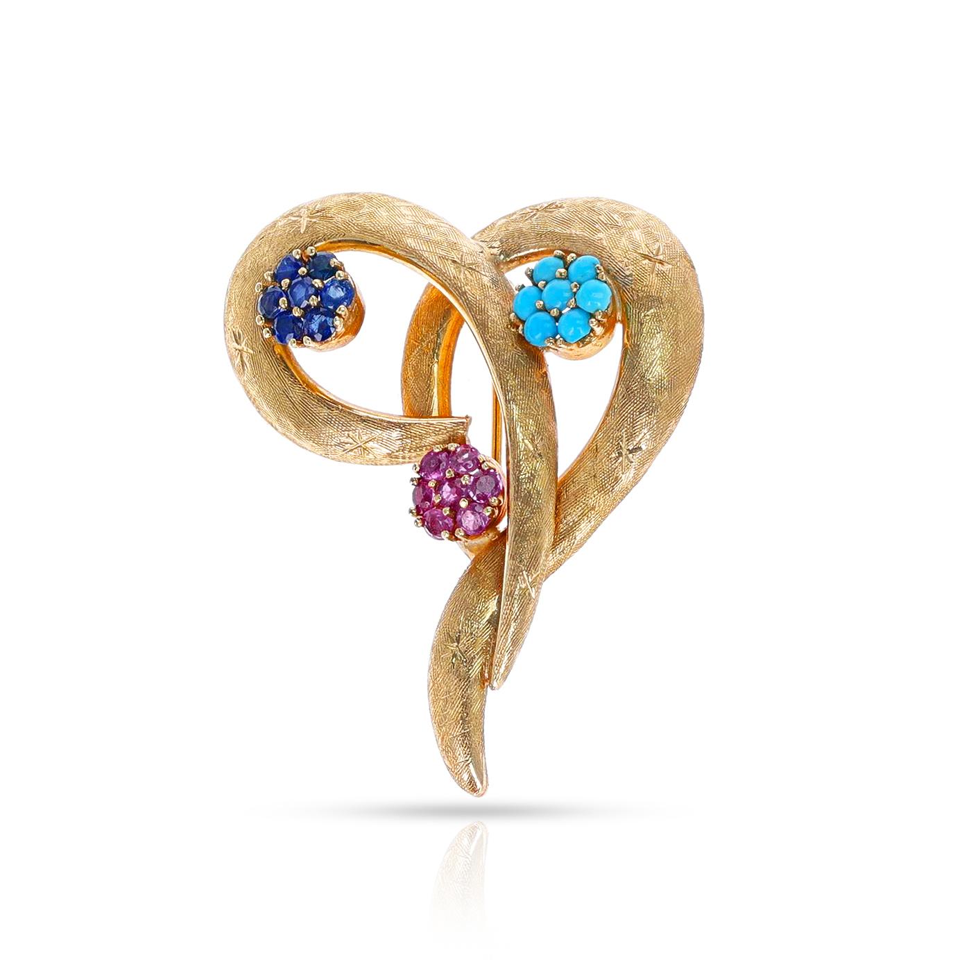 A Ruby, Sapphire and Turquoise Heart Brooch made in 14k Yellow Gold. The total weight is 11.80 grams. The dimensions are 1.75