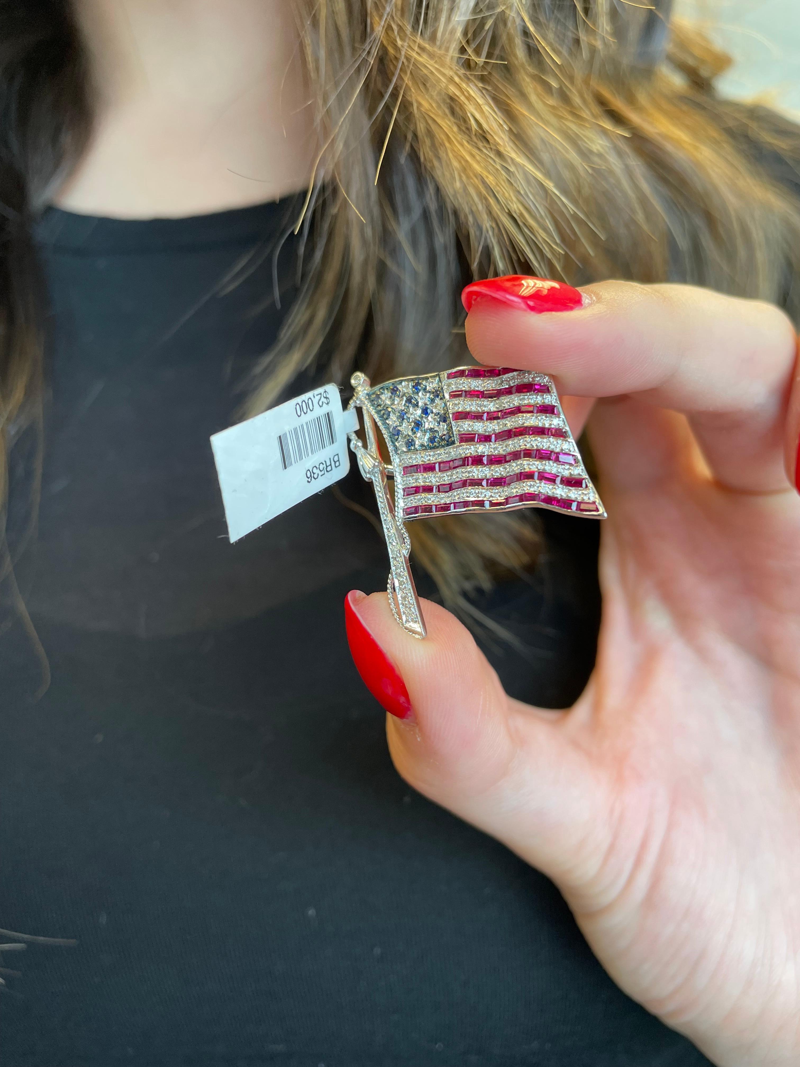 Stunning American flag brooch.
Approximately 1.50 carats of ruby, diamonds, and sapphires. 18-karat white gold with some black rhodium.
Accommodated with an up to date appraisal by a GIA G.G., please contact us with any questions. Thank you.

Item