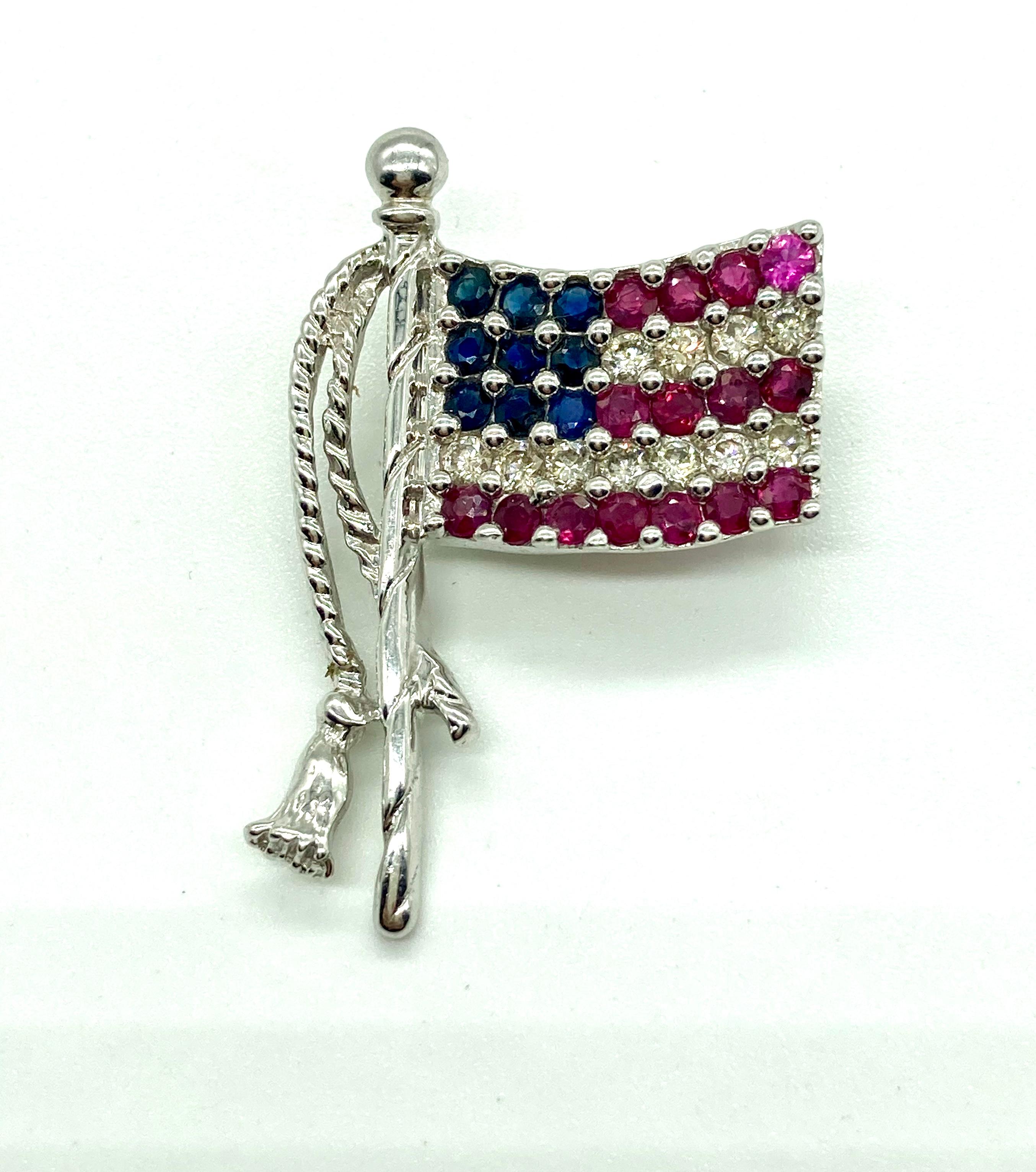 A beautiful American flag brooch embellished with rubies, sapphires, and diamonds. Late 20th century.